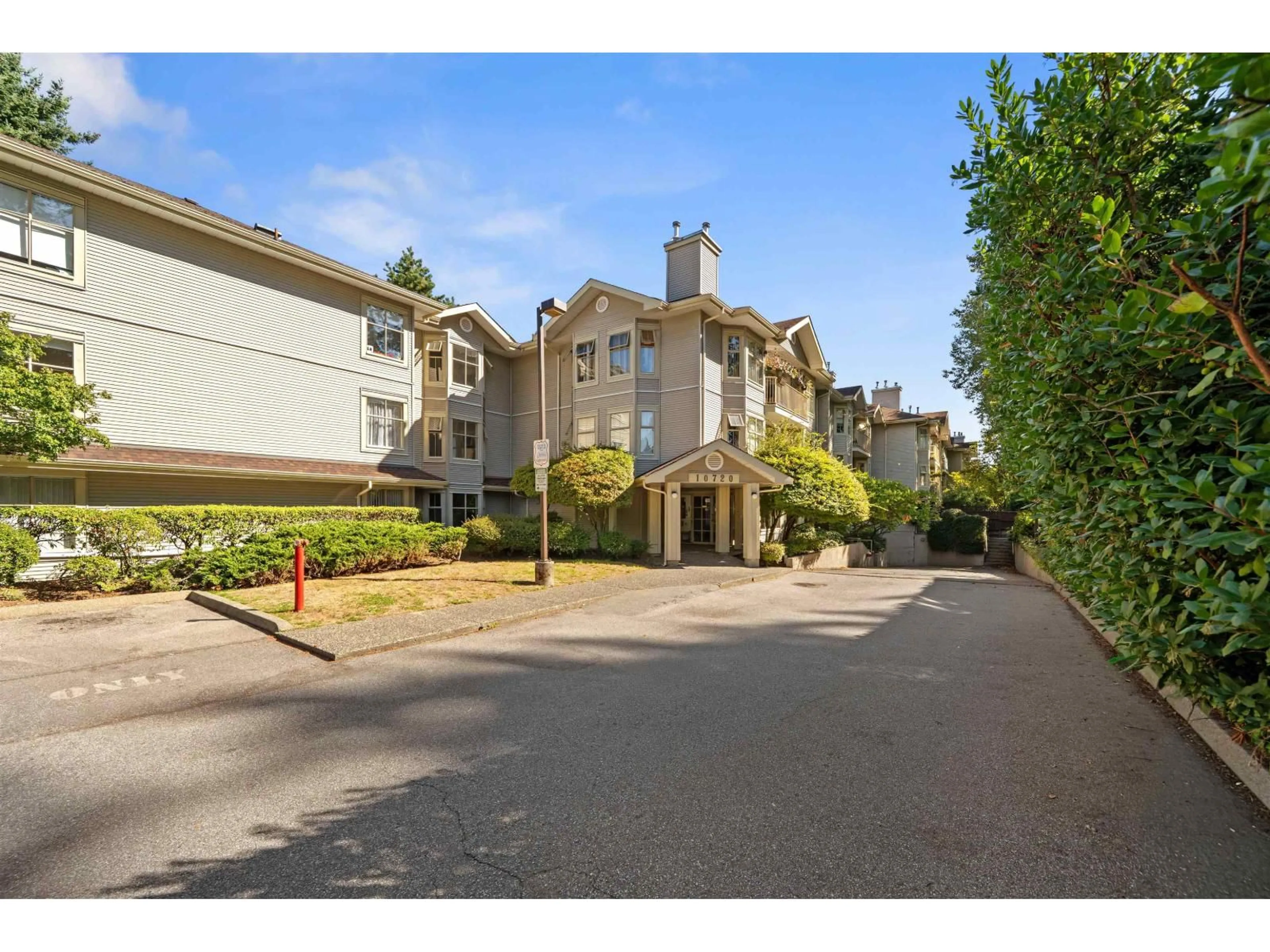 A pic from outside/outdoor area/front of a property/back of a property/a pic from drone, street for 303 - 10720 138 STREET, Surrey British Columbia V3T4K5