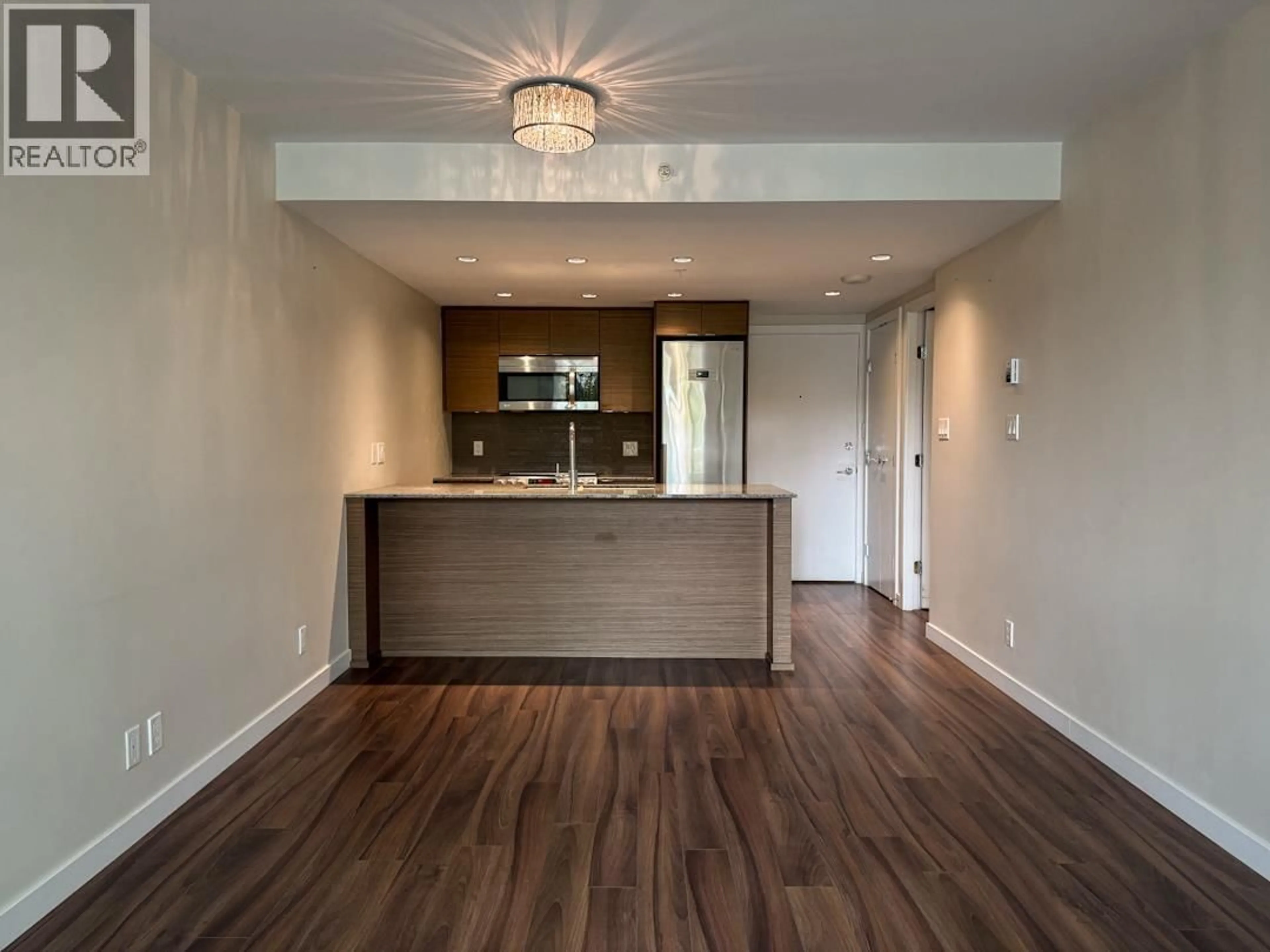 Open concept kitchen, wood/laminate floor for 321 - 135 17TH STREET, North Vancouver British Columbia V7L0C4