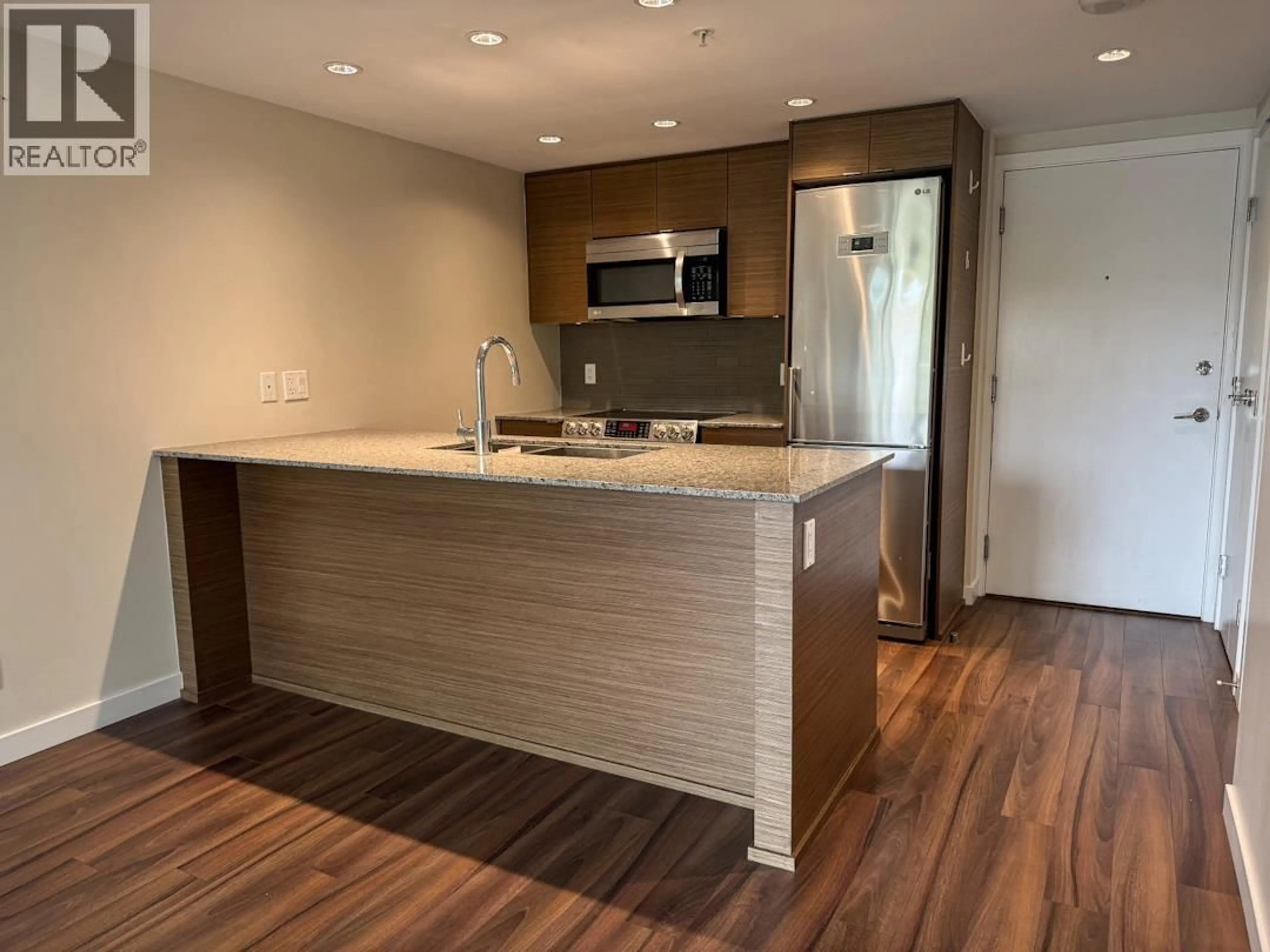Open concept kitchen, wood/laminate floor for 321 - 135 17TH STREET, North Vancouver British Columbia V7L0C4
