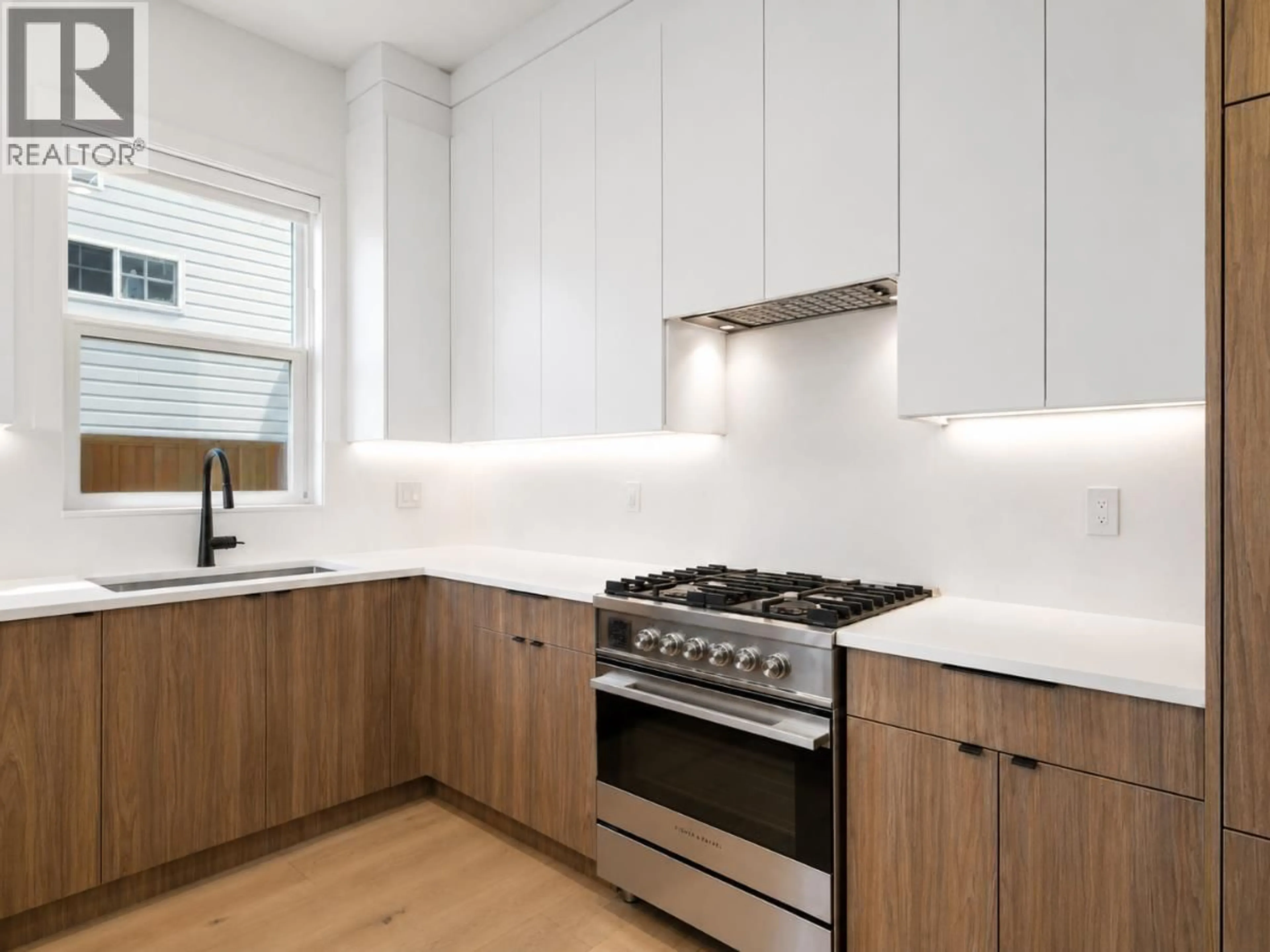 Contemporary kitchen, wood/laminate floor for 1907 40TH AVENUE, Vancouver British Columbia V5P1J1