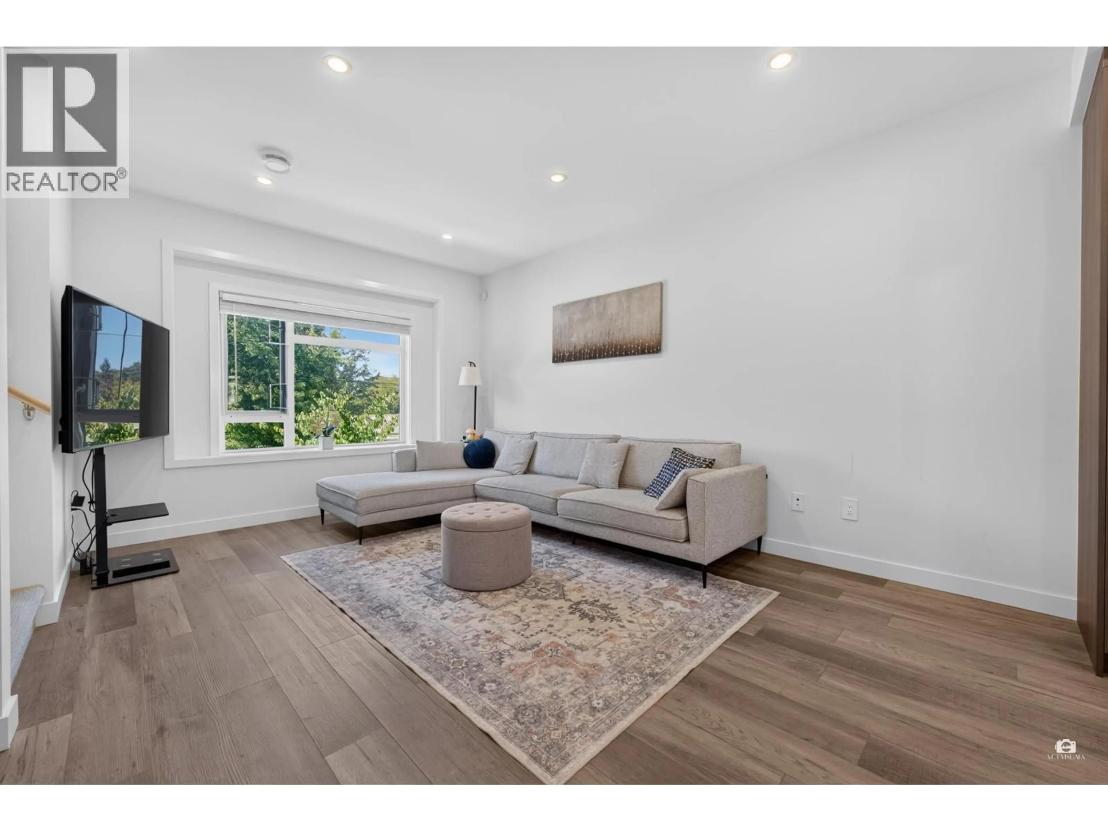 Living room with furniture, wood/laminate floor for 4 - 7580 NO. 1 ROAD, Richmond British Columbia V7C0G6