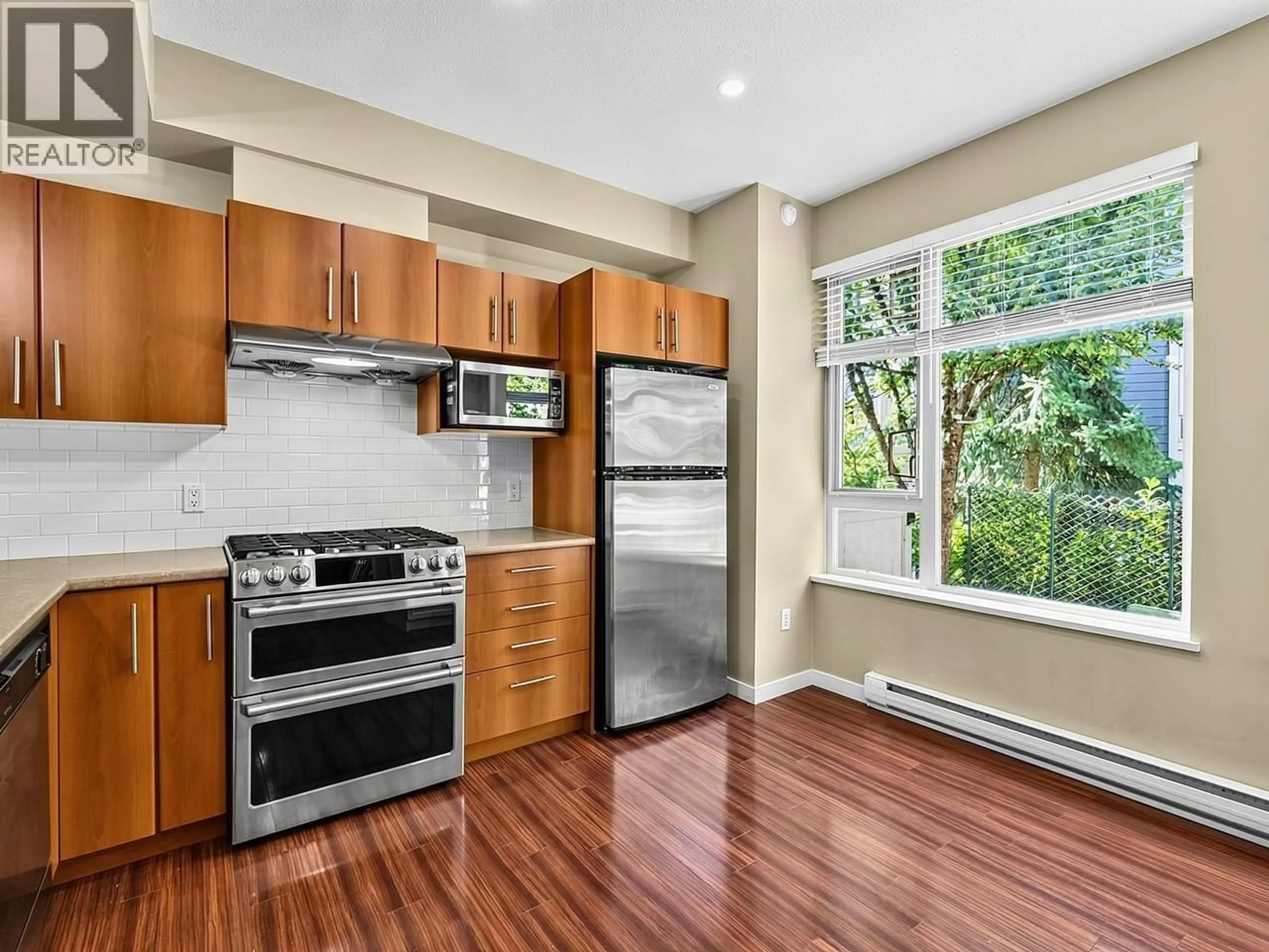 Open concept kitchen, wood/laminate floor for 122 - 9229 UNIVERSITY CRESCENT, Burnaby British Columbia V5A4Z2