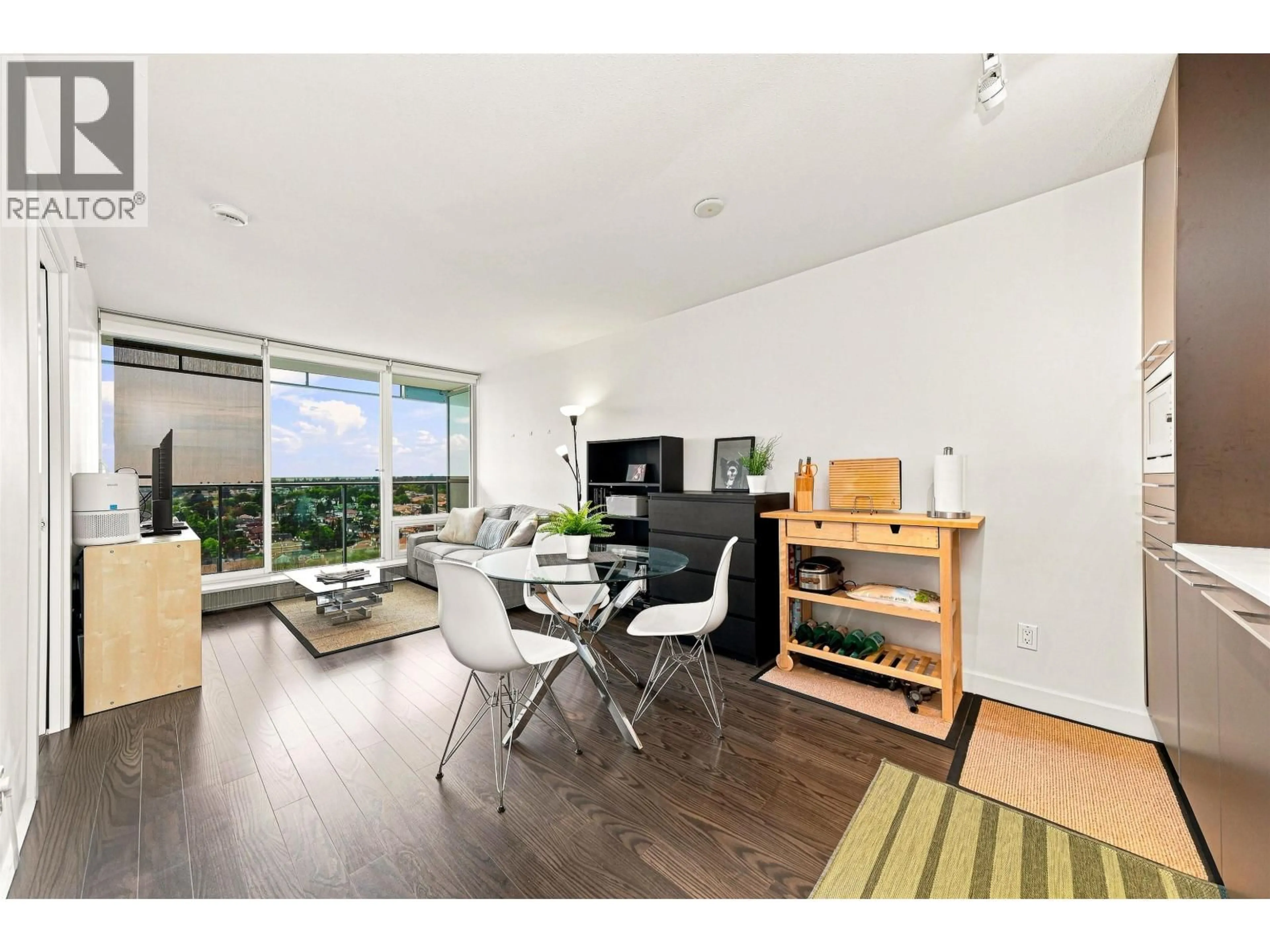 Living room with furniture, wood/laminate floor for 2409 - 8131 NUNAVUT LANE, Vancouver British Columbia V5X0E2