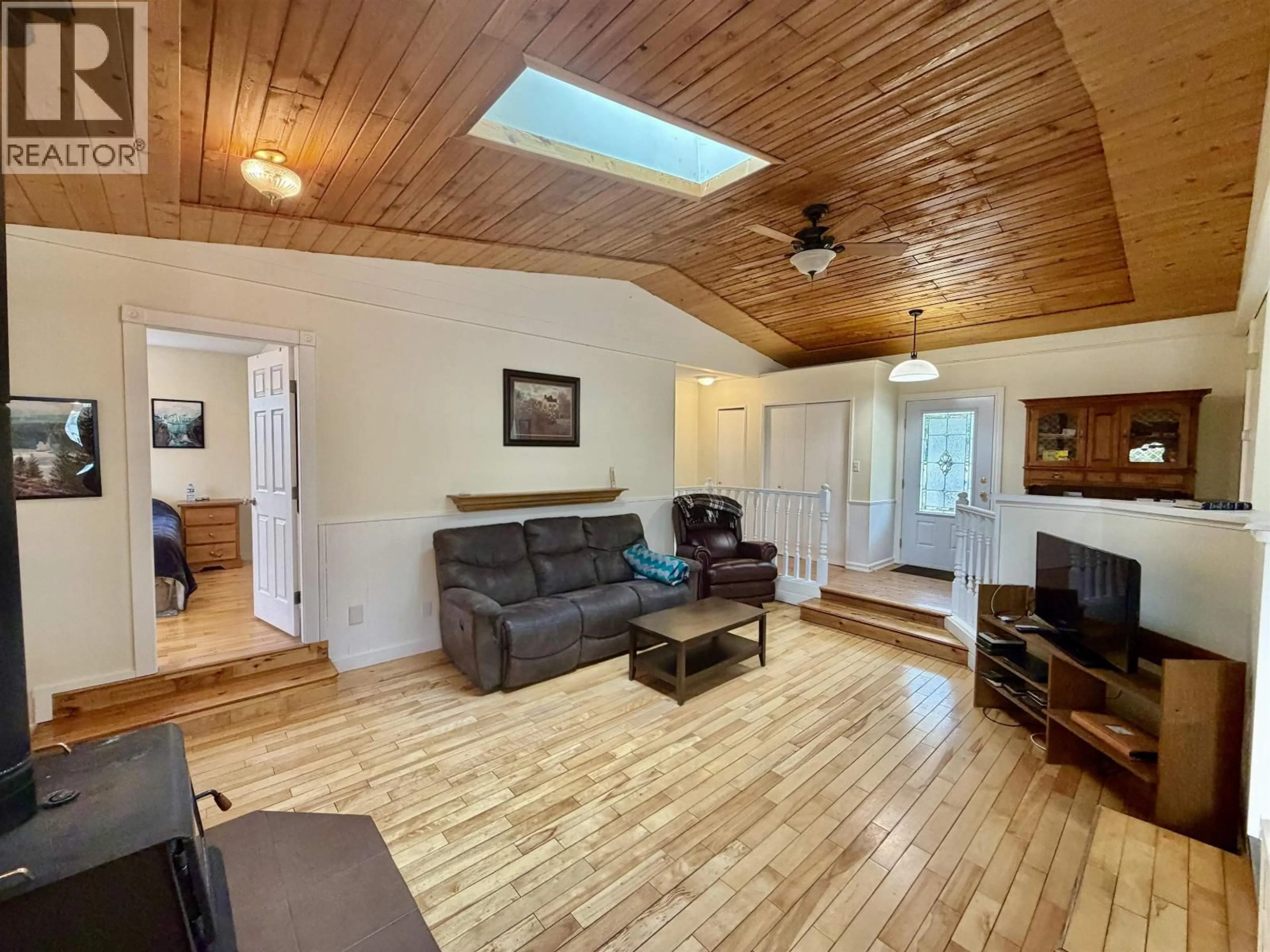 Living room with furniture, wood/laminate floor for 4729 KITWANGA DRIVE, 108 Mile Ranch British Columbia V0K2Z0