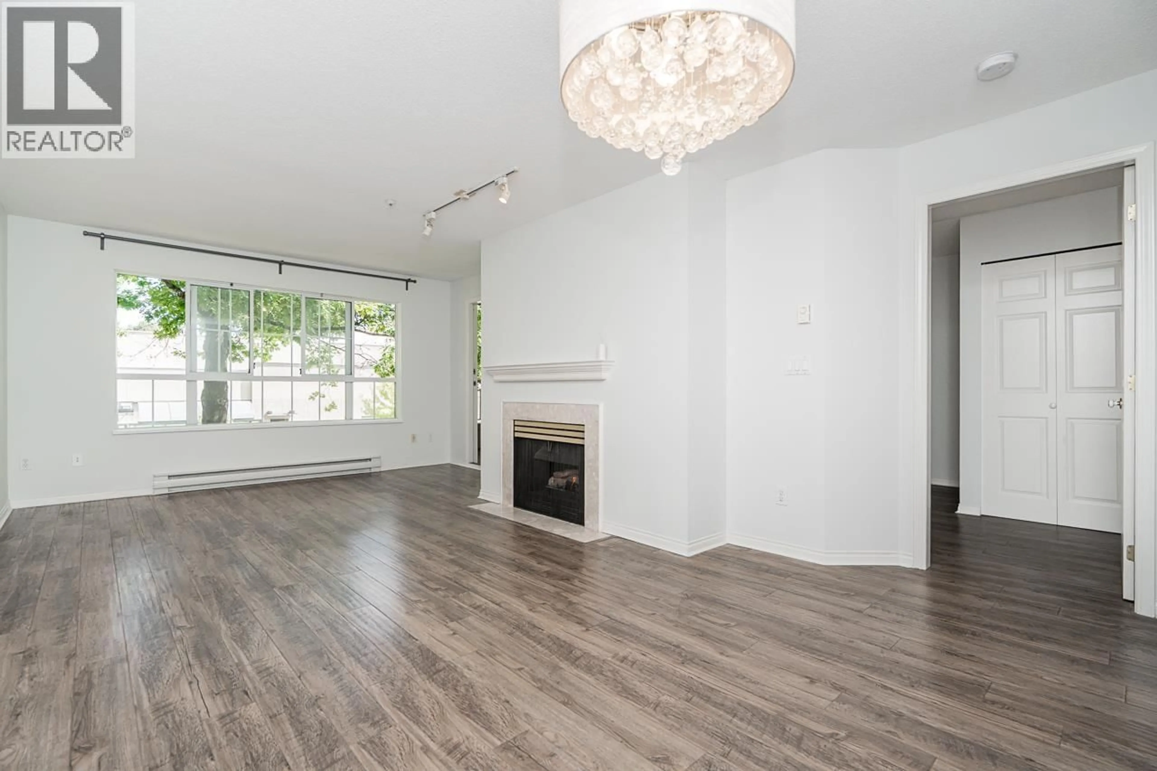 Living room with furniture, wood/laminate floor for 206 - 2990 PRINCESS CRESCENT, Coquitlam British Columbia V3B7R3
