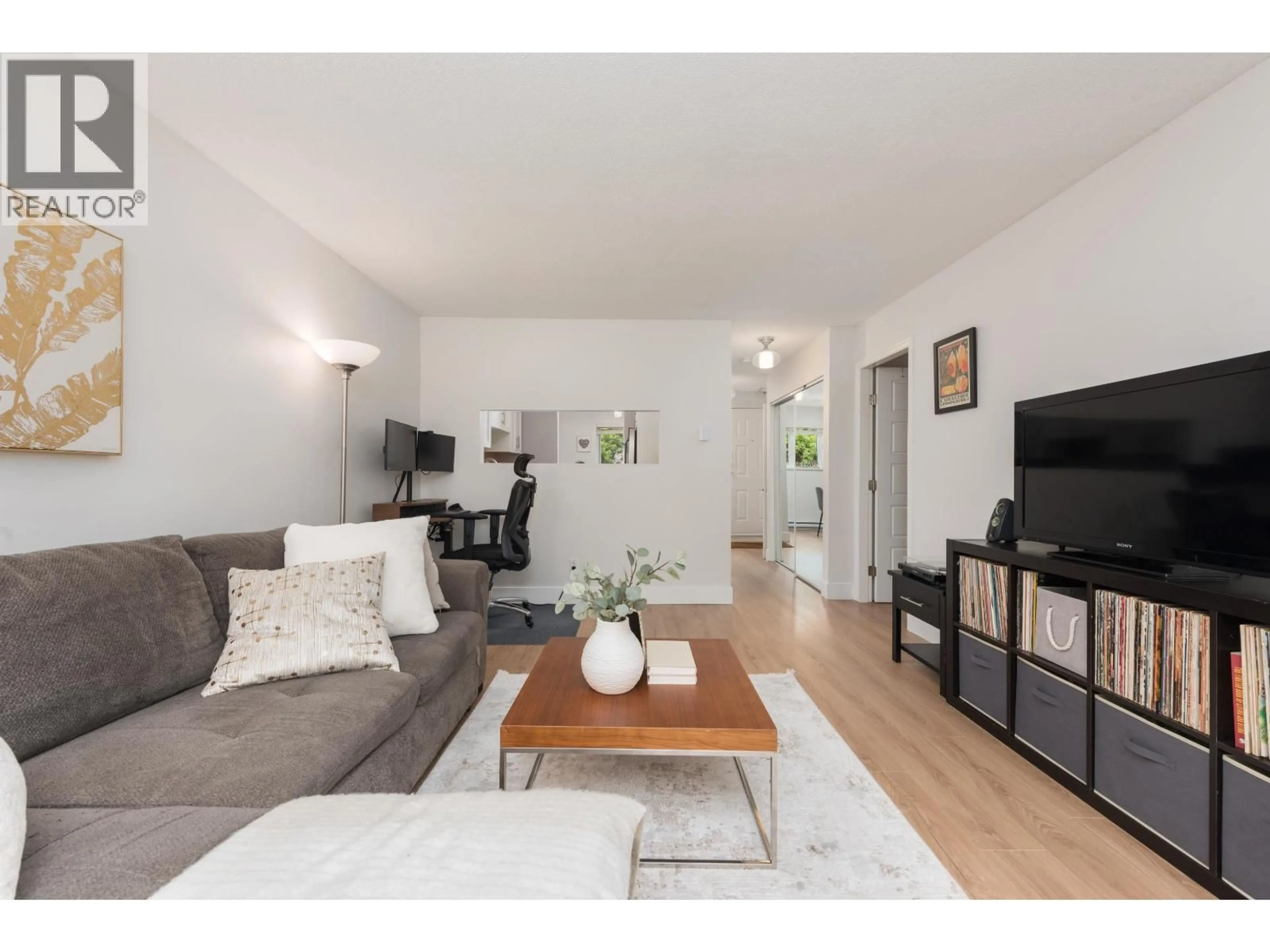 Living room with furniture, wood/laminate floor for 104 - 1330 GRAVELEY STREET, Vancouver British Columbia V5L3A2
