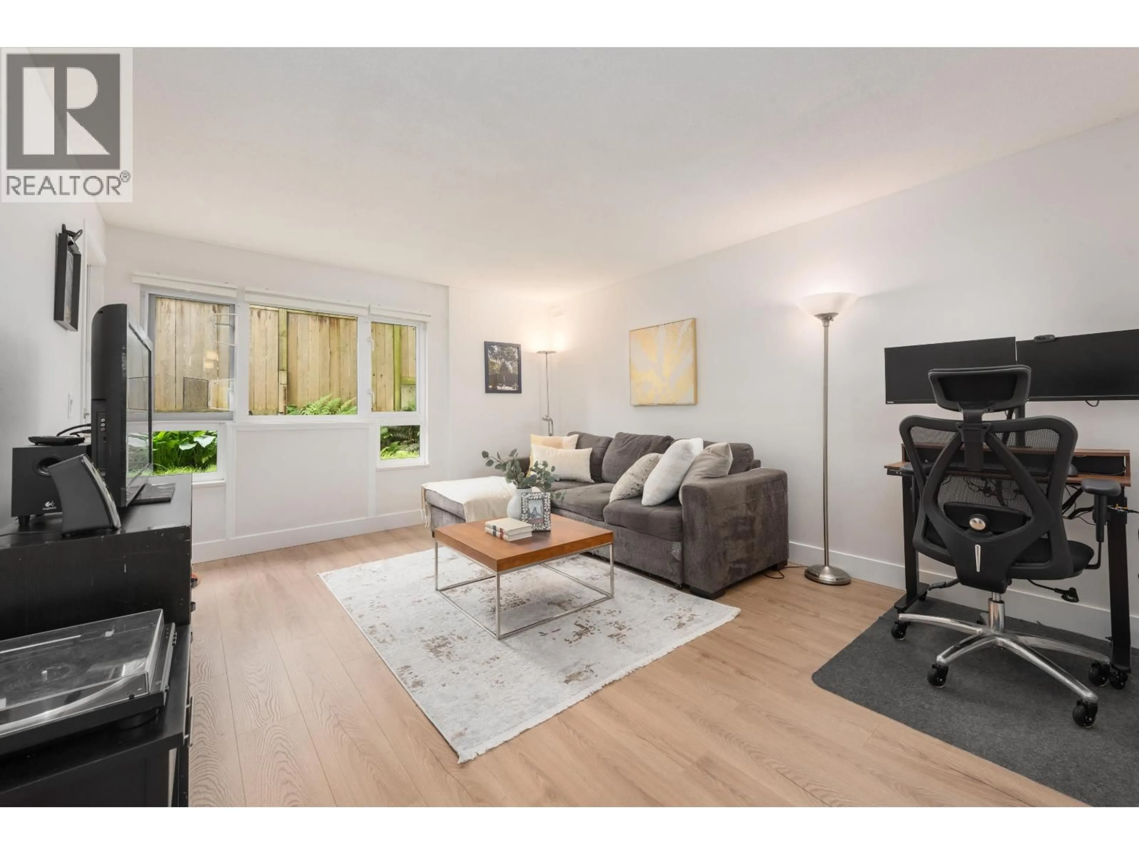 Living room with furniture, wood/laminate floor for 104 - 1330 GRAVELEY STREET, Vancouver British Columbia V5L3A2