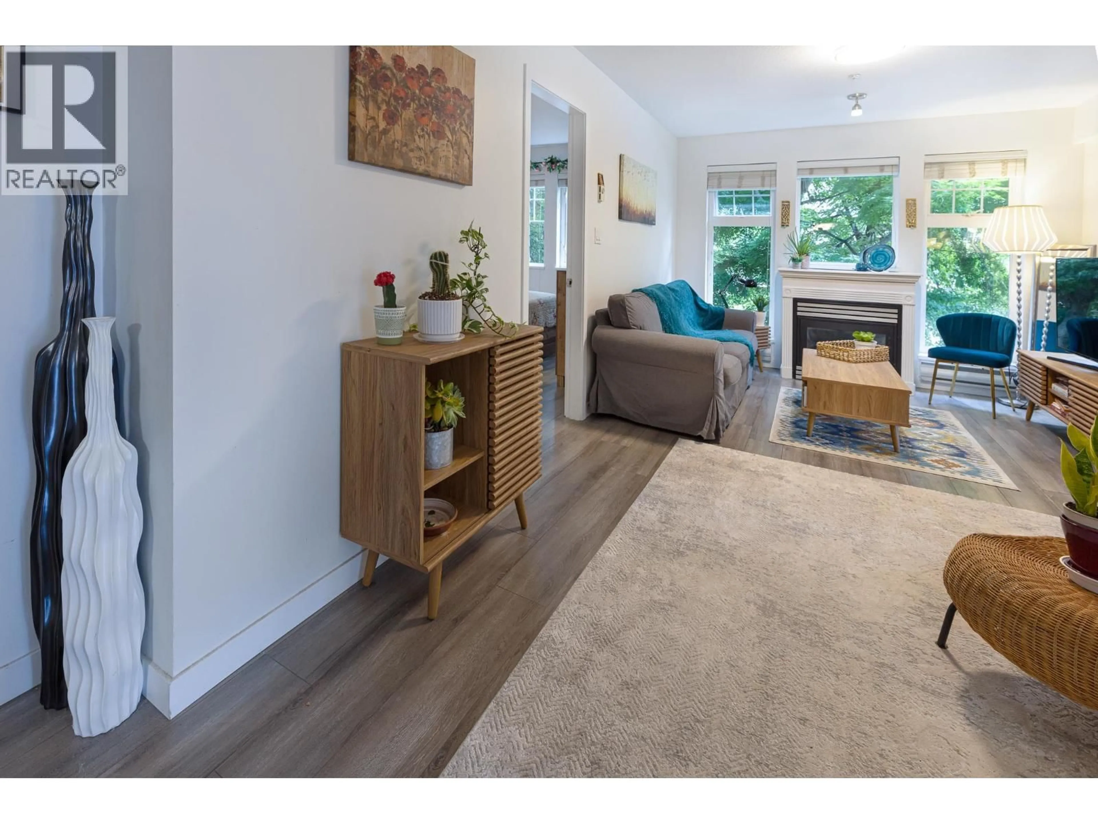 Living room with furniture, wood/laminate floor for 213 - 3085 PRIMROSE LANE, Coquitlam British Columbia V3B7S3