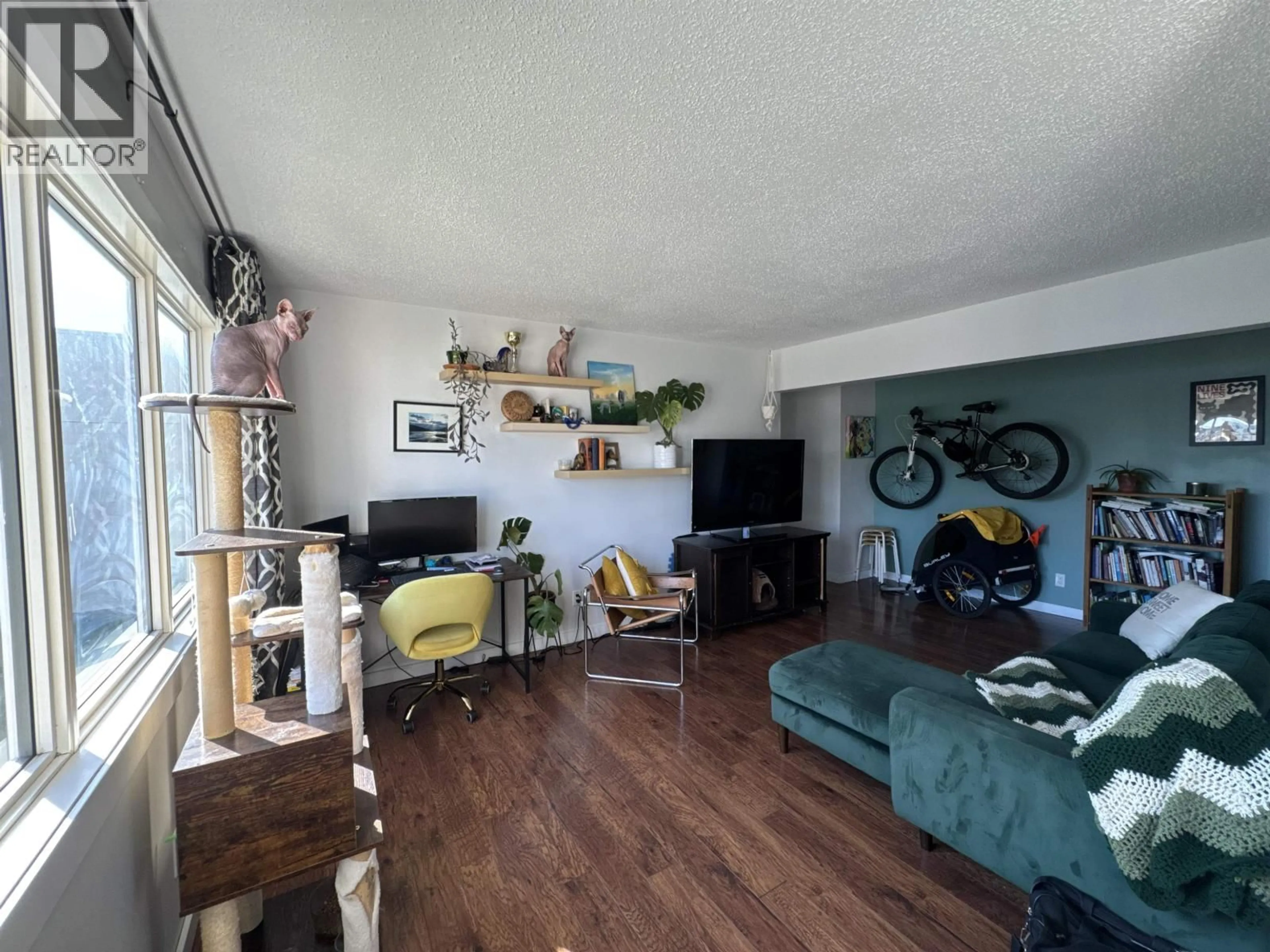 Living room with furniture, wood/laminate floor for 208 - 9815 104 AVENUE, Fort St. John British Columbia V1J2K4