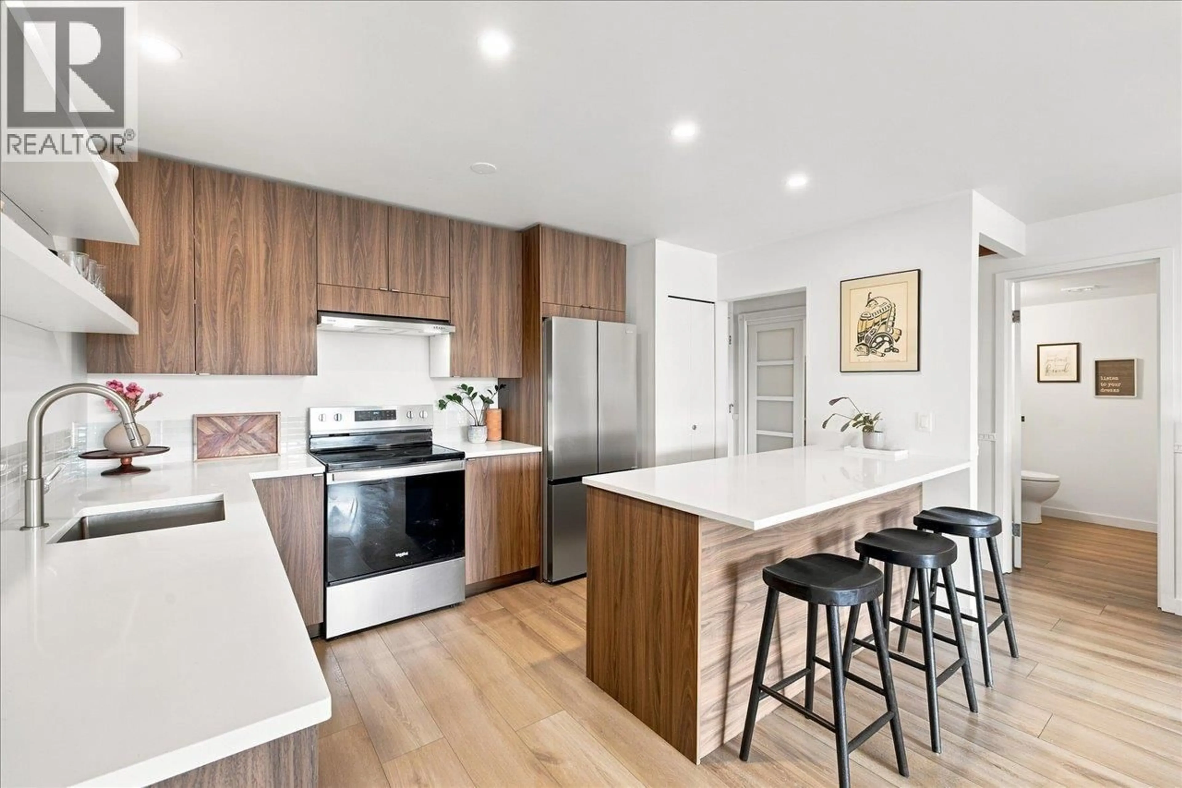 Open concept kitchen, wood/laminate floor for 207 - 236 2ND STREET, North Vancouver British Columbia V7M1C6