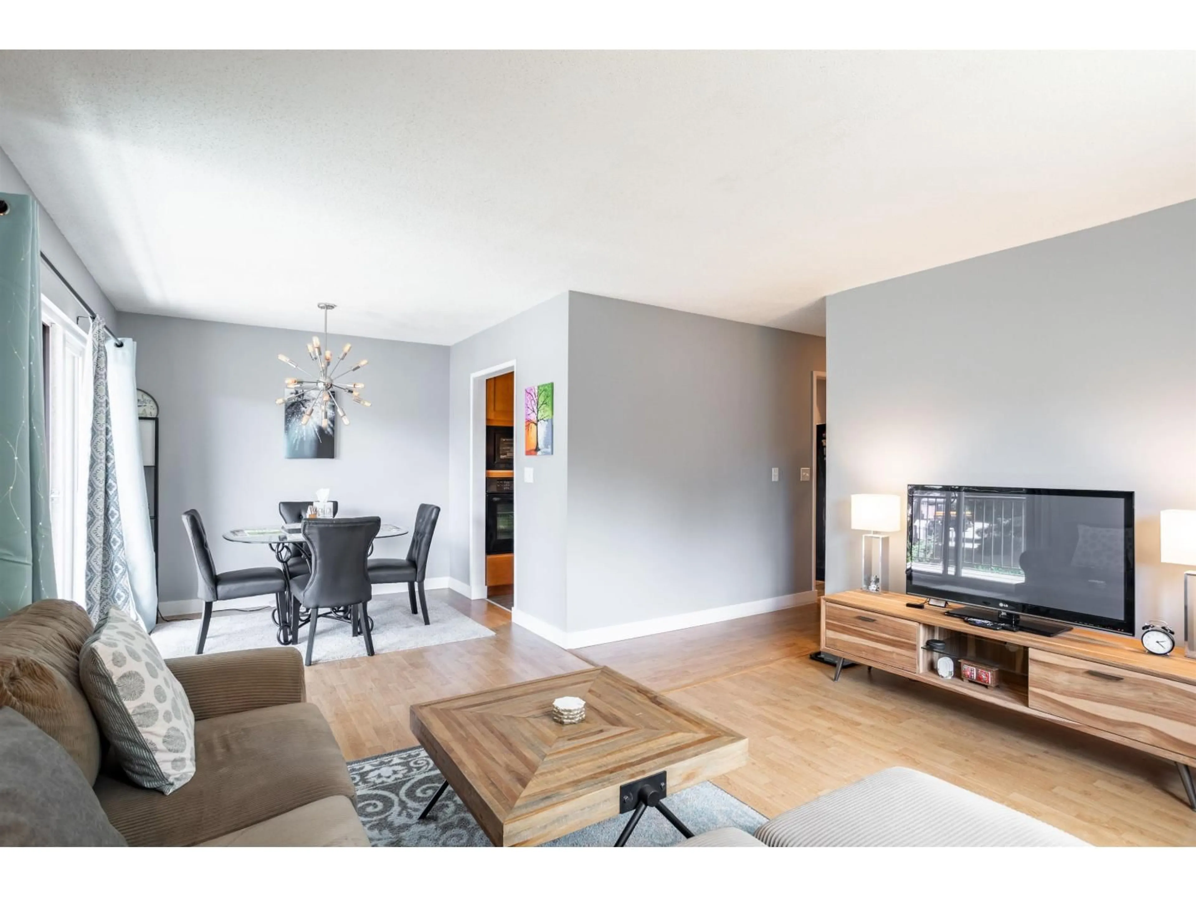 Living room with furniture, wood/laminate floor for 210 - 5191 203 STREET, Langley British Columbia V3A1V6