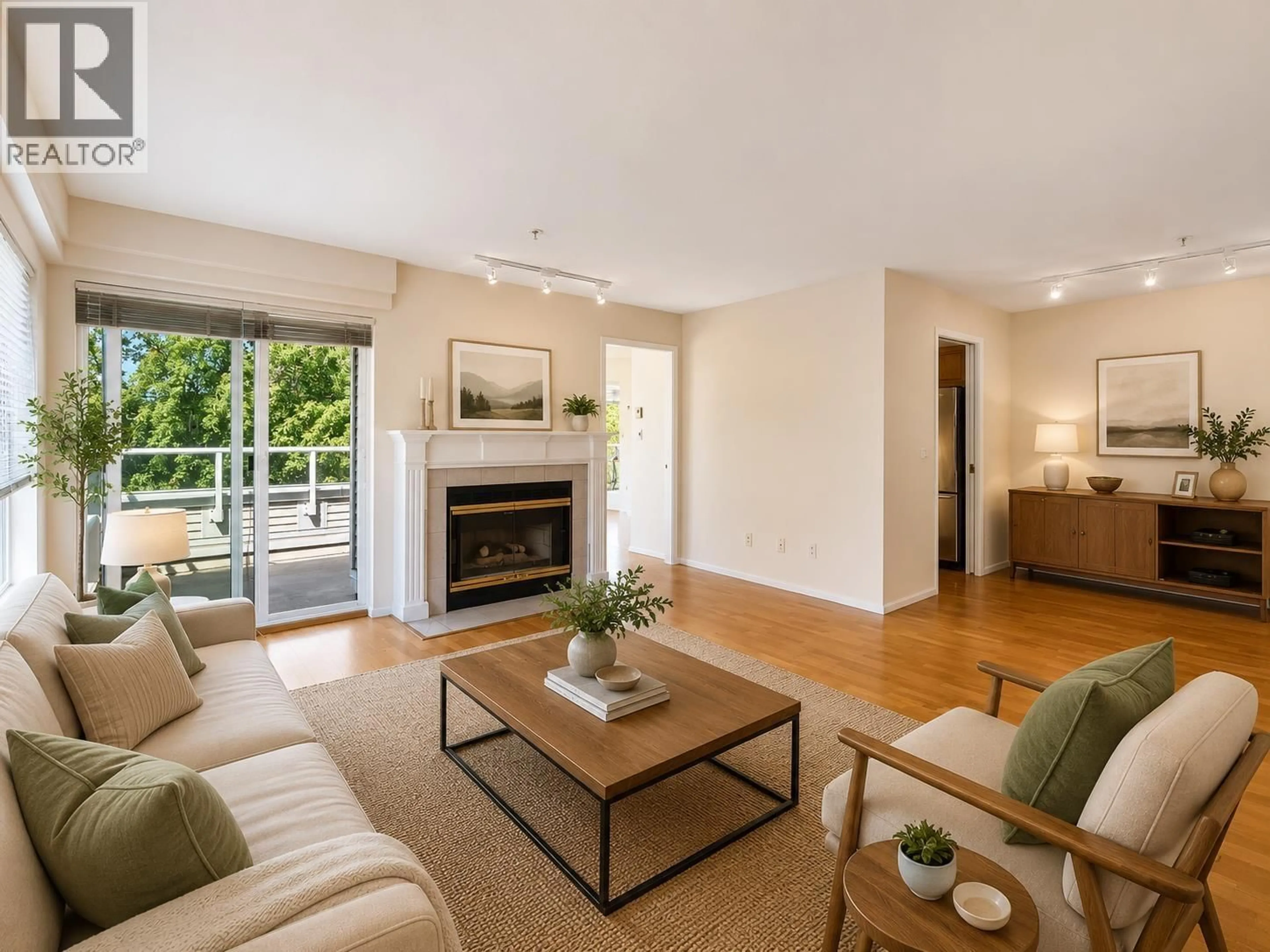 Living room with furniture, wood/laminate floor for 401 - 7620 COLUMBIA STREET, Vancouver British Columbia V5X4S8