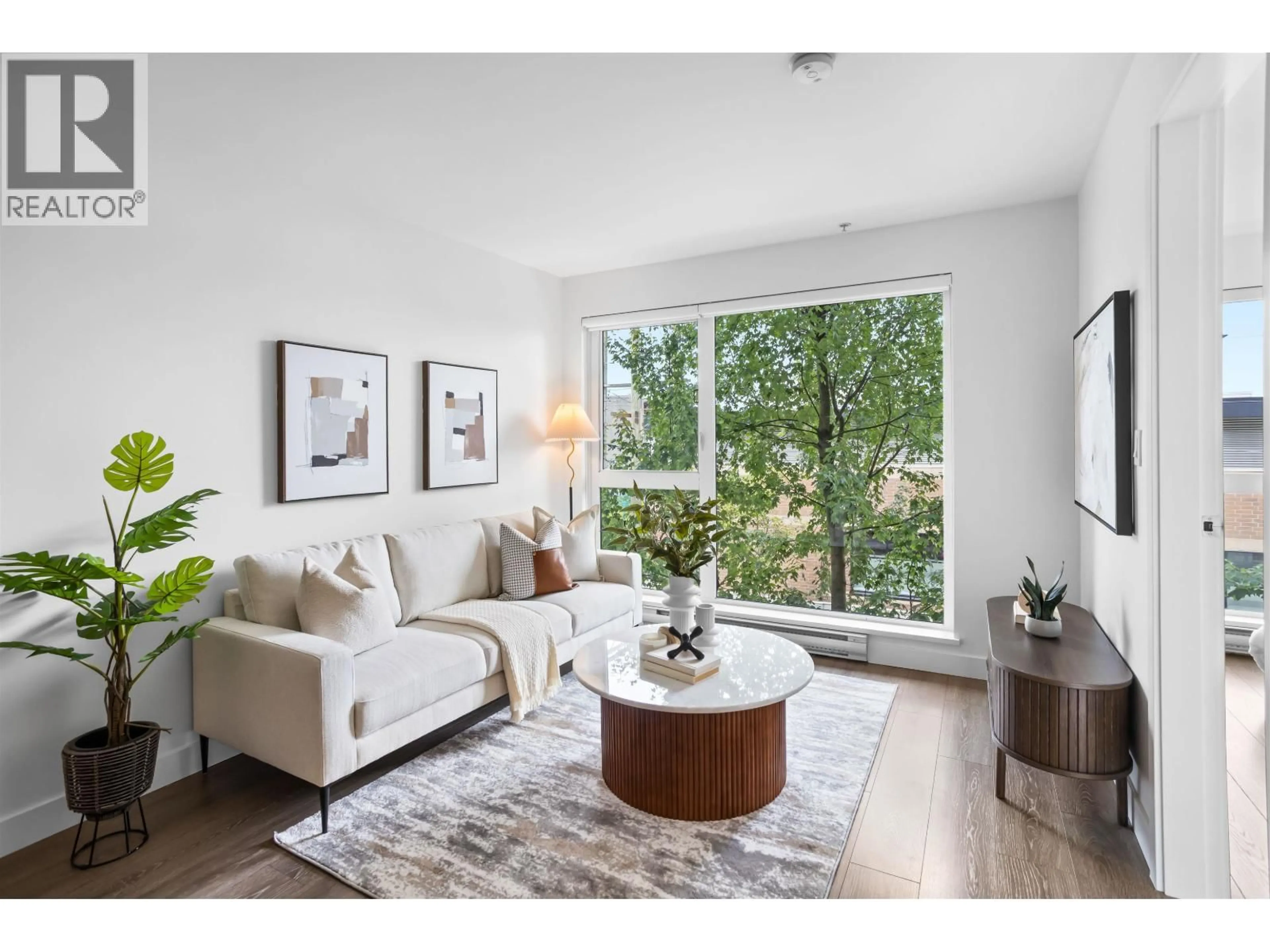 Living room with furniture, wood/laminate floor for 211 - 1588 HASTINGS STREET, Vancouver British Columbia V5L0B8
