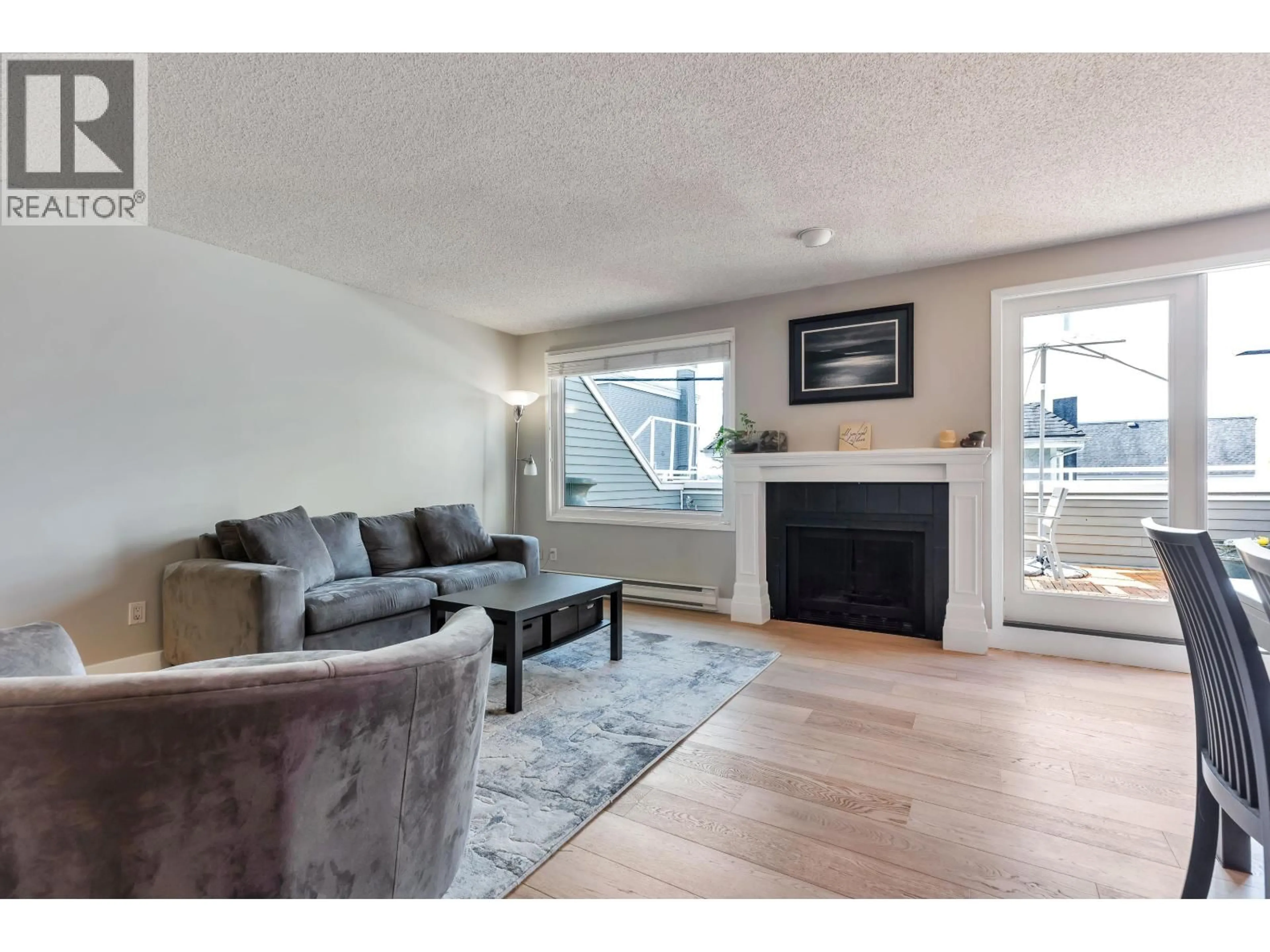Living room with furniture, wood/laminate floor for 304 - 223 KEITH ROAD, North Vancouver British Columbia V7L1V4