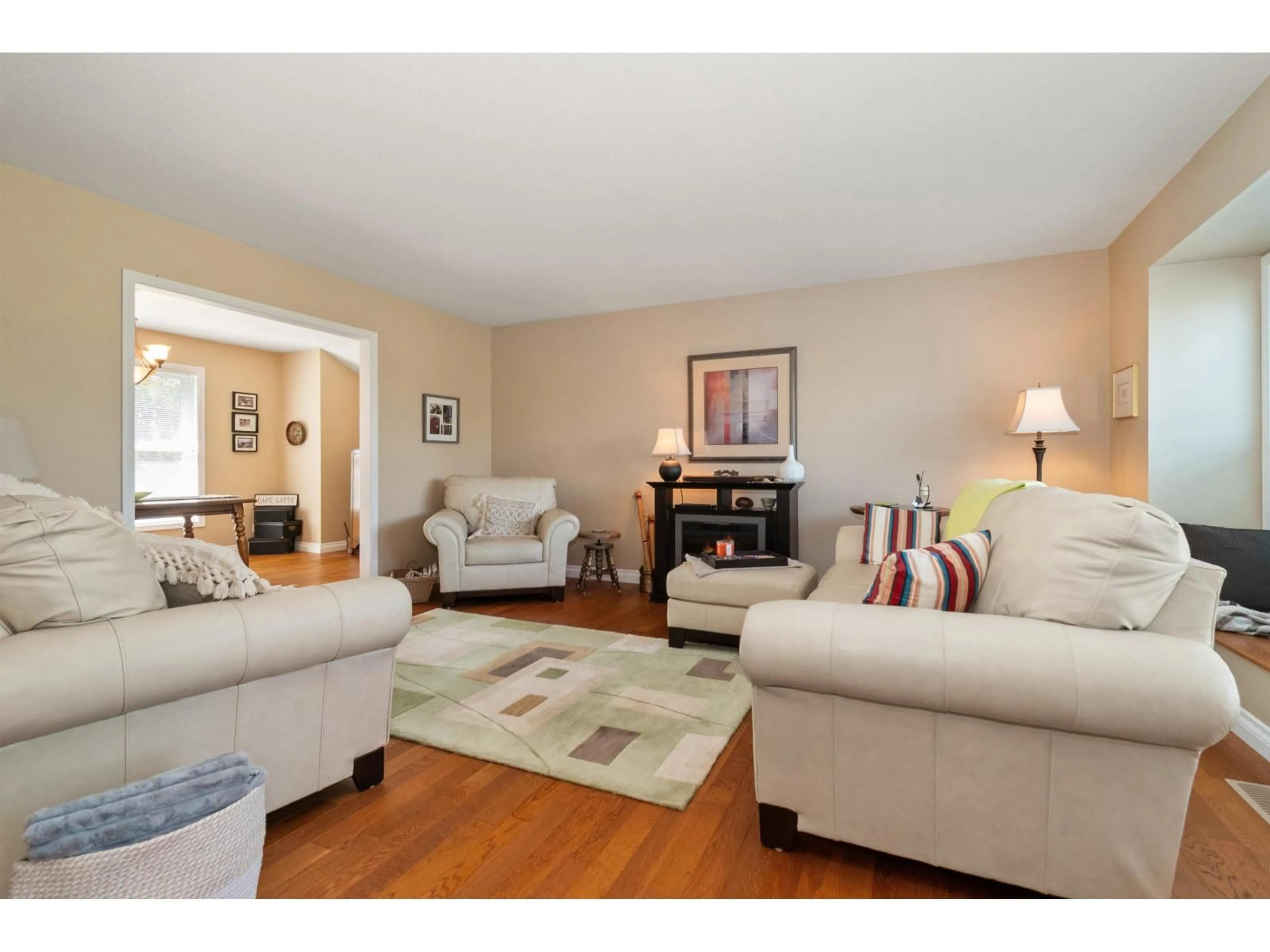 Living room with furniture, wood/laminate floor for 46054 BRITTON AVENUE, Chilliwack British Columbia V2R2P9