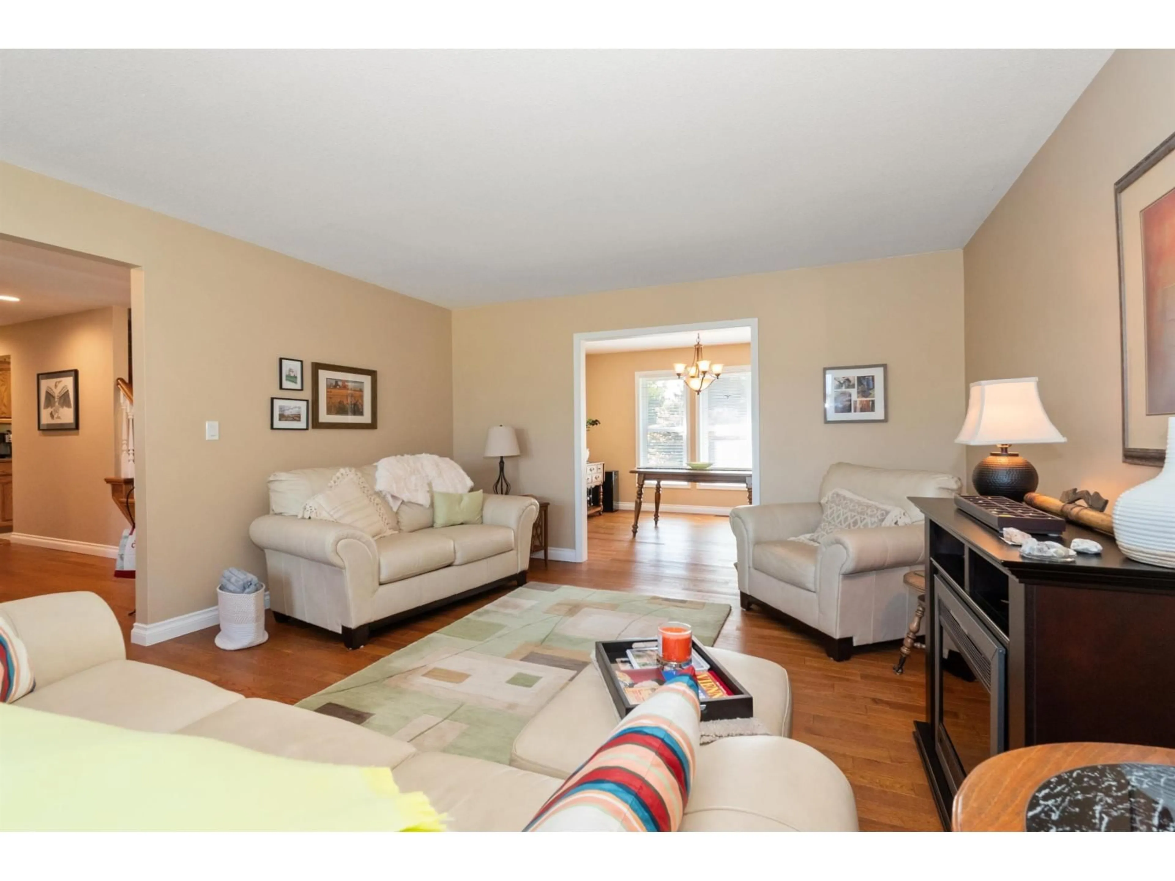 Living room with furniture, wood/laminate floor for 46054 BRITTON AVENUE, Chilliwack British Columbia V2R2P9