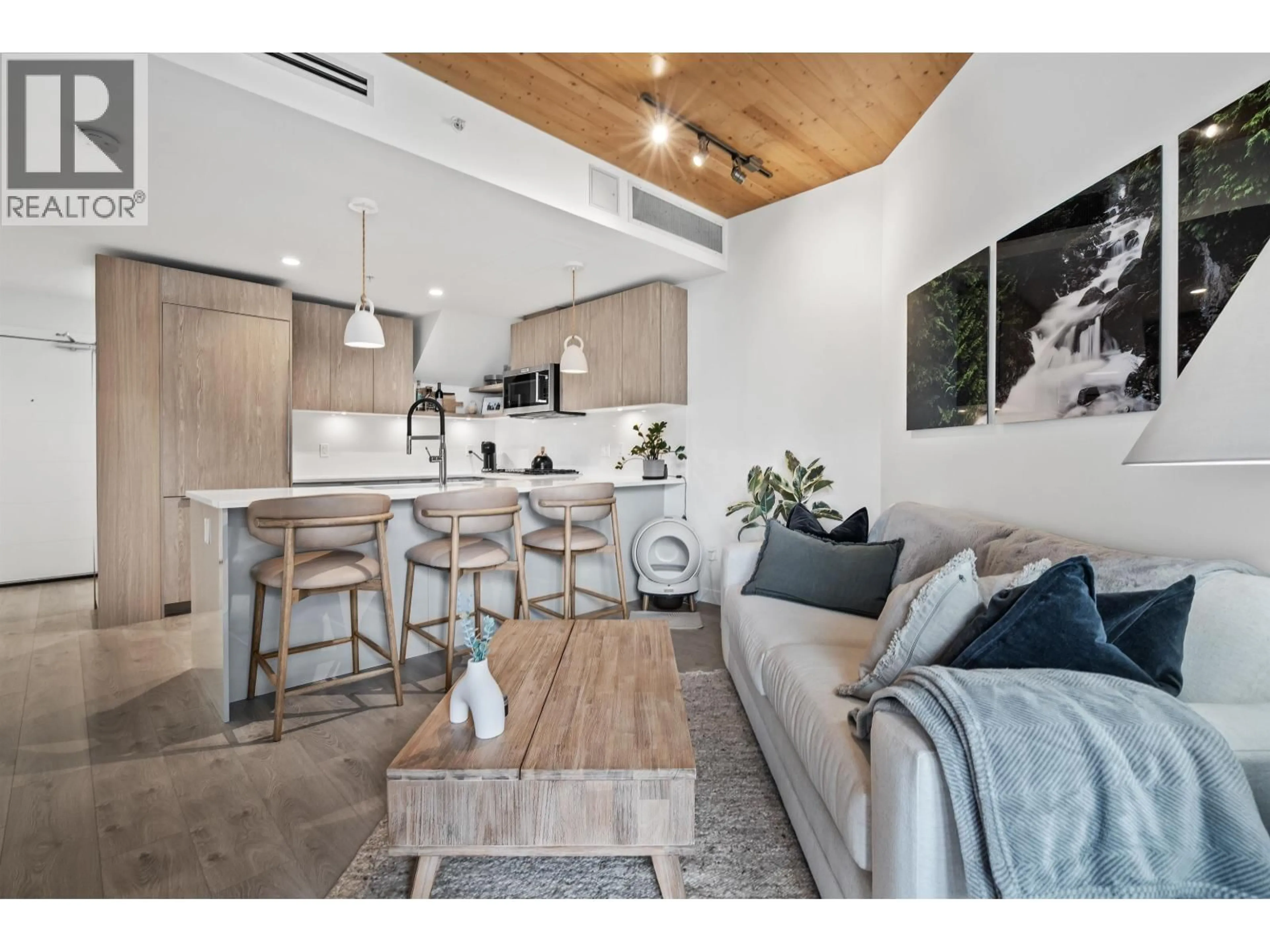 Living room with furniture, wood/laminate floor for 614 - 108 8TH STREET, North Vancouver British Columbia V7L0H1