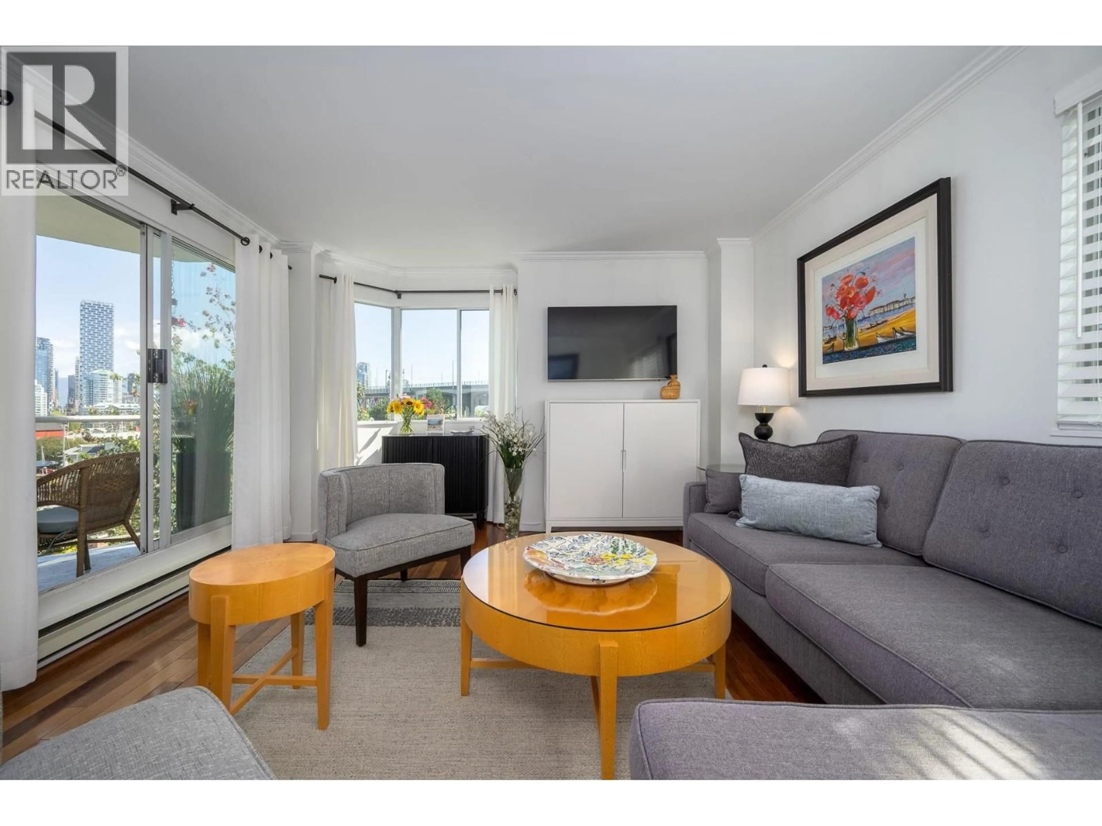 Living room with furniture, wood/laminate floor for 607 - 1508 MARINER WALK, Vancouver British Columbia V6J4X9