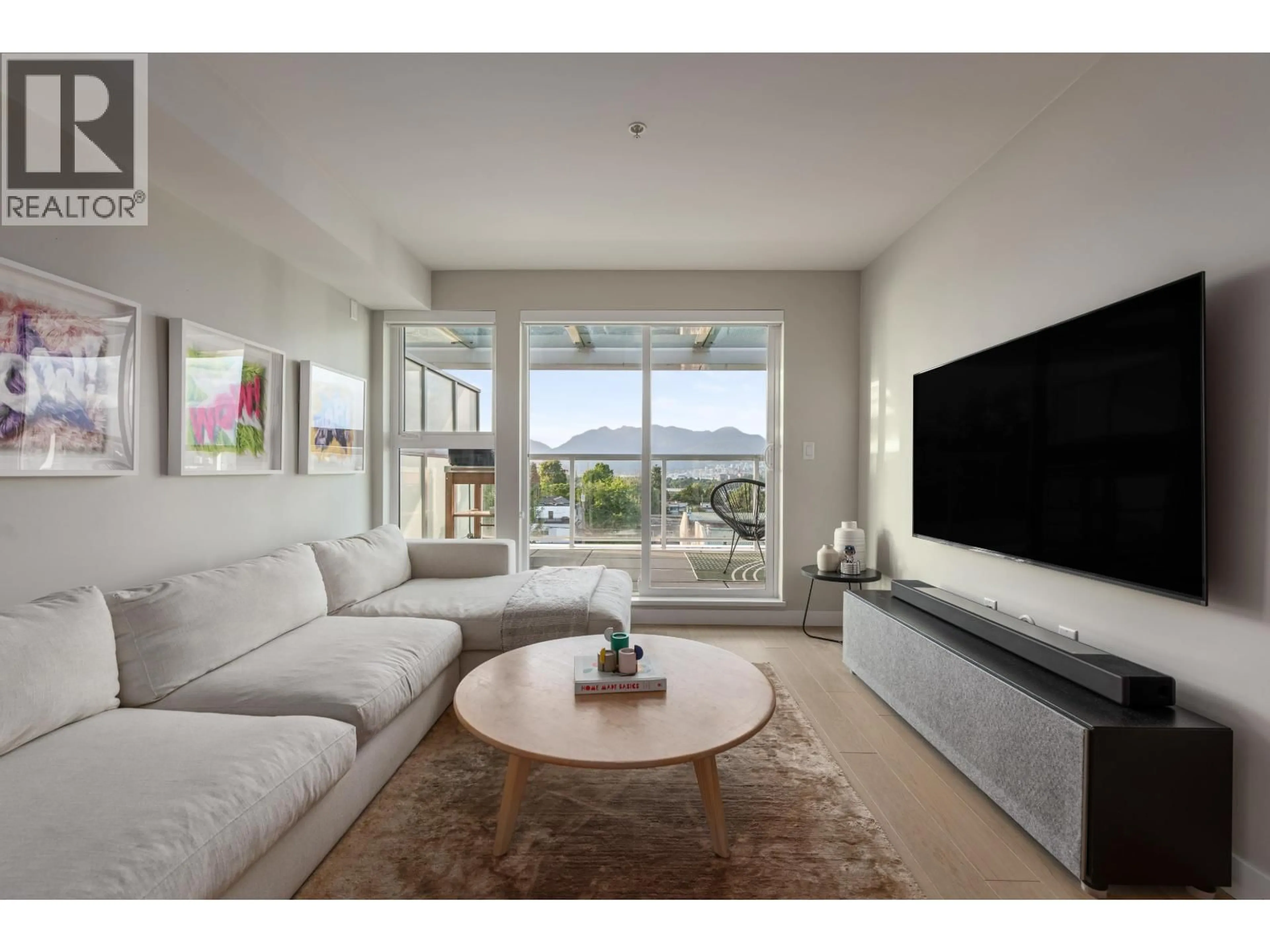 Living room with furniture, unknown for 406 - 2508 FRASER STREET, Vancouver British Columbia V5T3V4