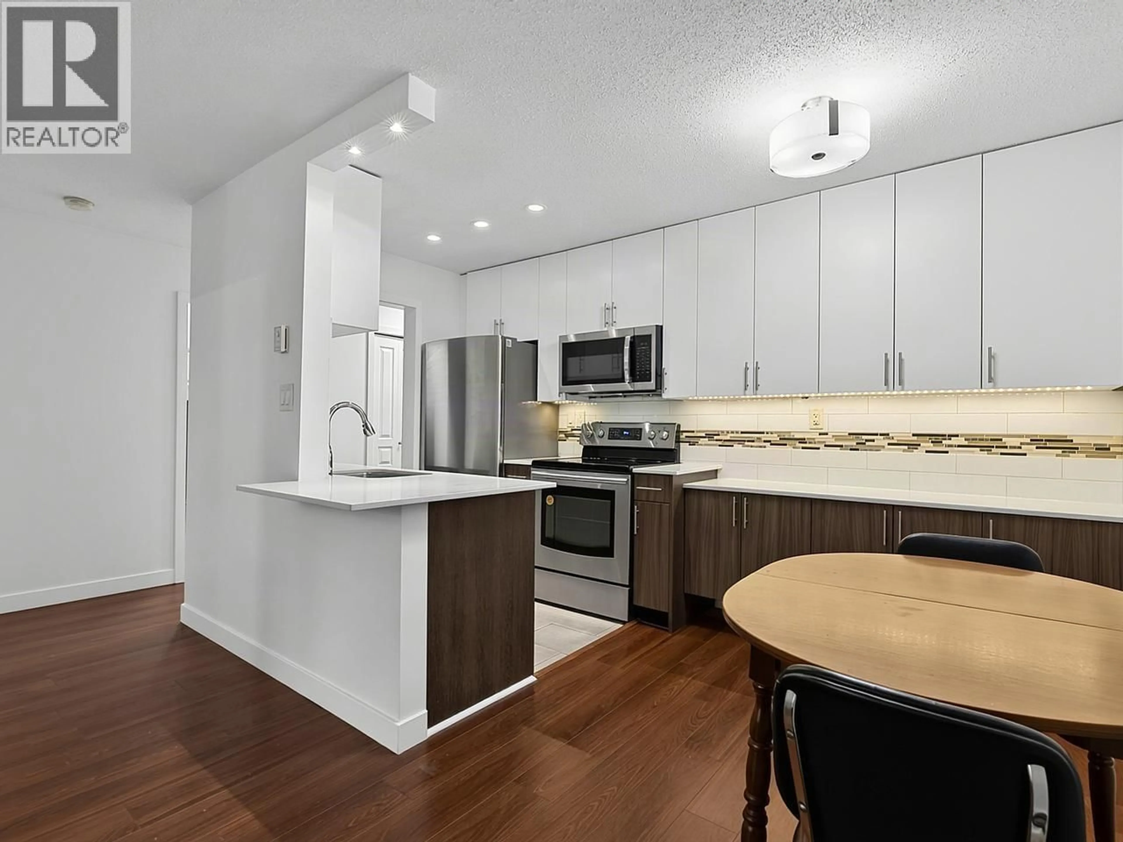 Open concept kitchen, wood/laminate floor for 101 - 750 7TH AVENUE, Vancouver British Columbia V5T4H5