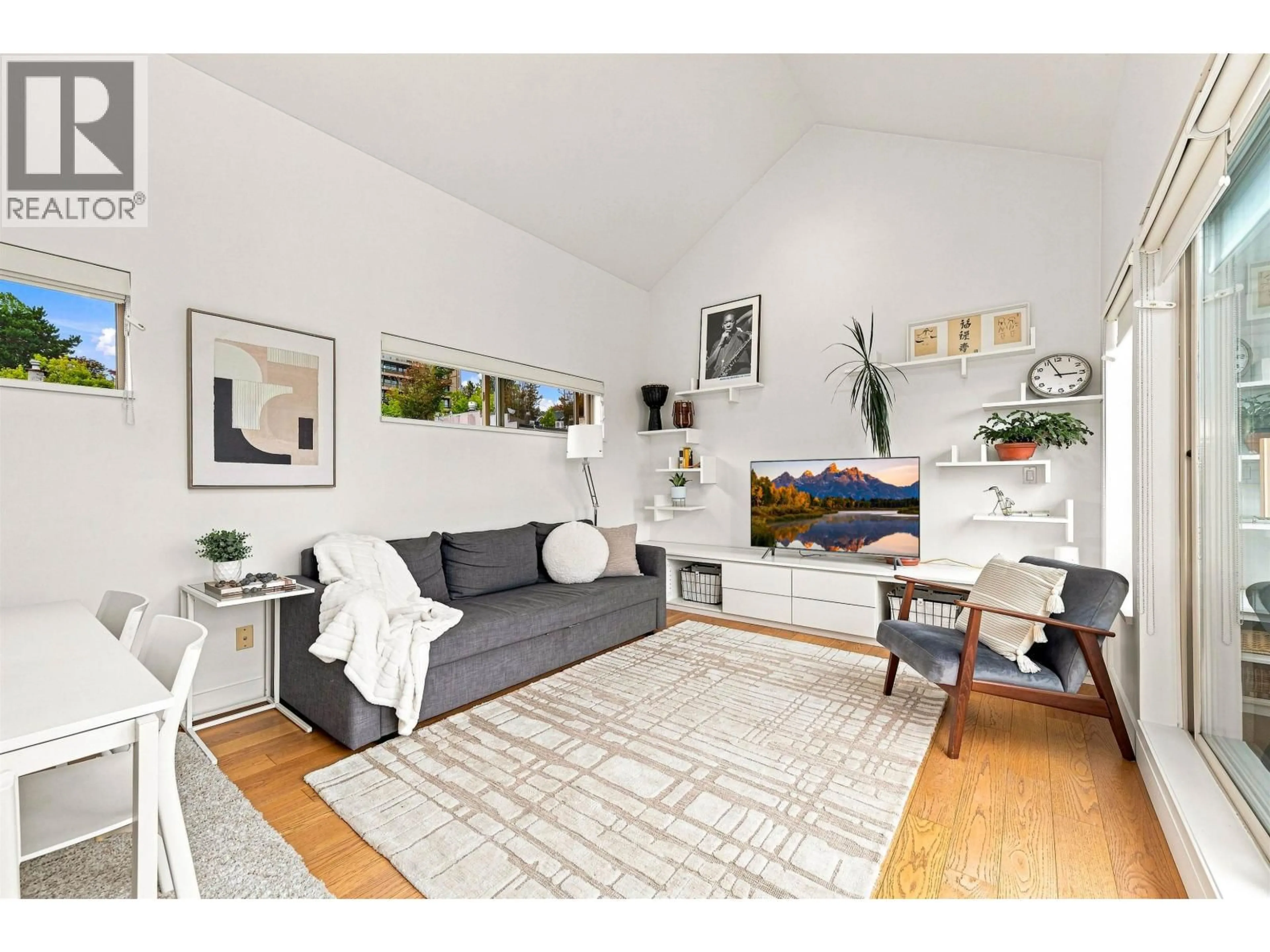 Living room with furniture, wood/laminate floor for 19 - 3737 PENDER STREET, Burnaby British Columbia V5C2L2