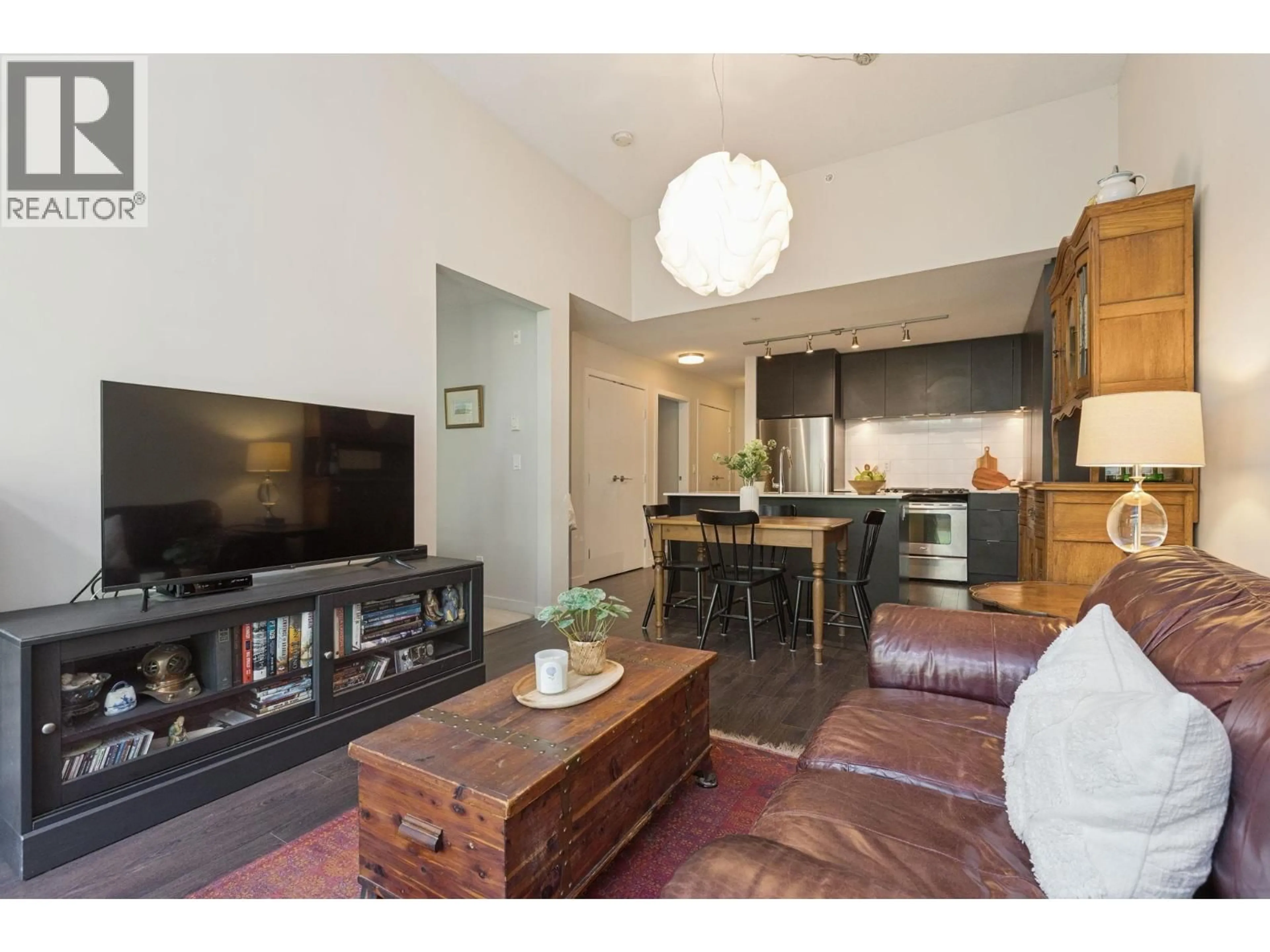 Living room with furniture, wood/laminate floor for 506 - 1679 LLOYD AVENUE, North Vancouver British Columbia V7P0A9