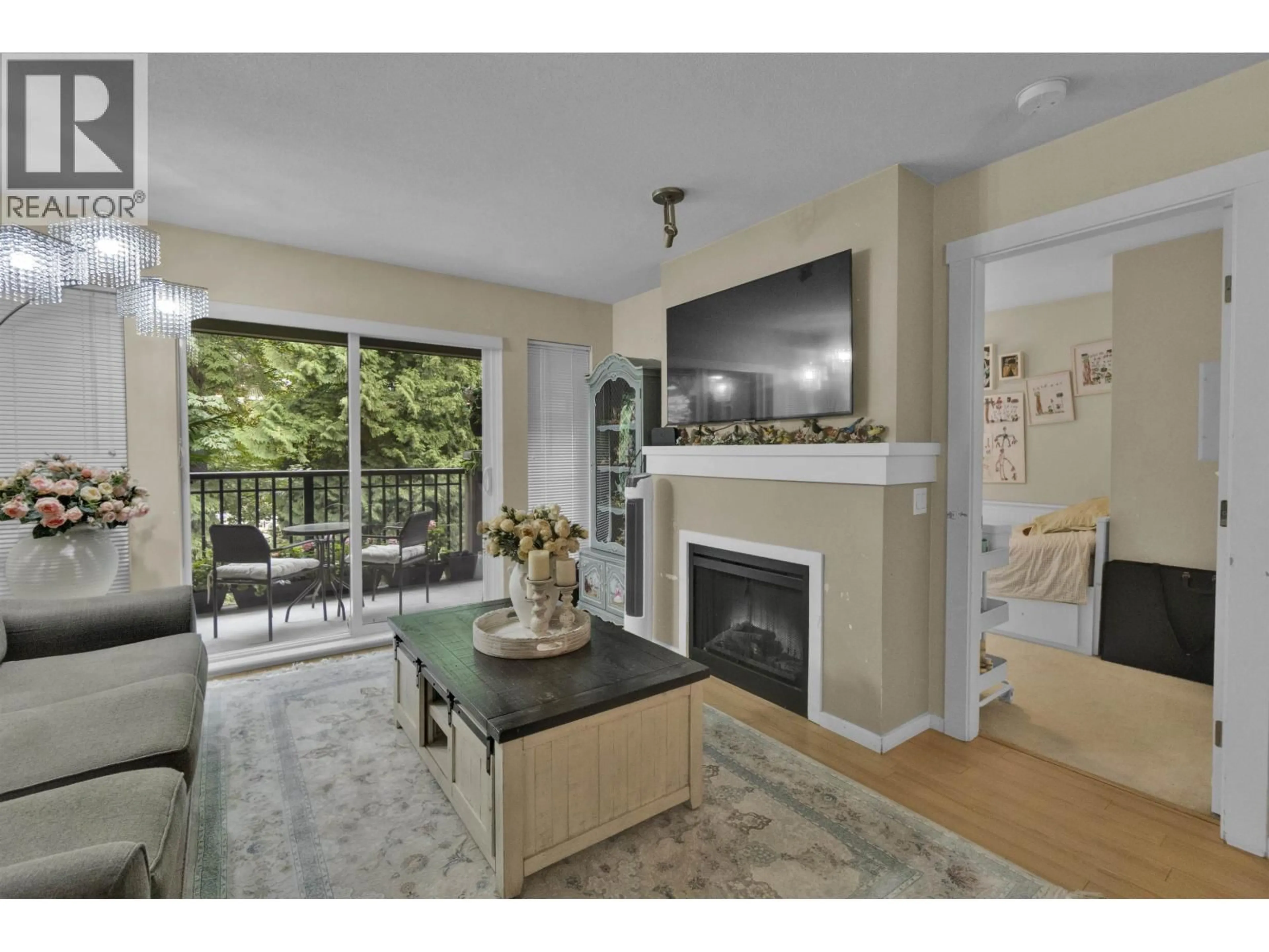 Living room with furniture, wood/laminate floor for 306 - 9283 GOVERNMENT ROAD, Burnaby British Columbia V3N0A5
