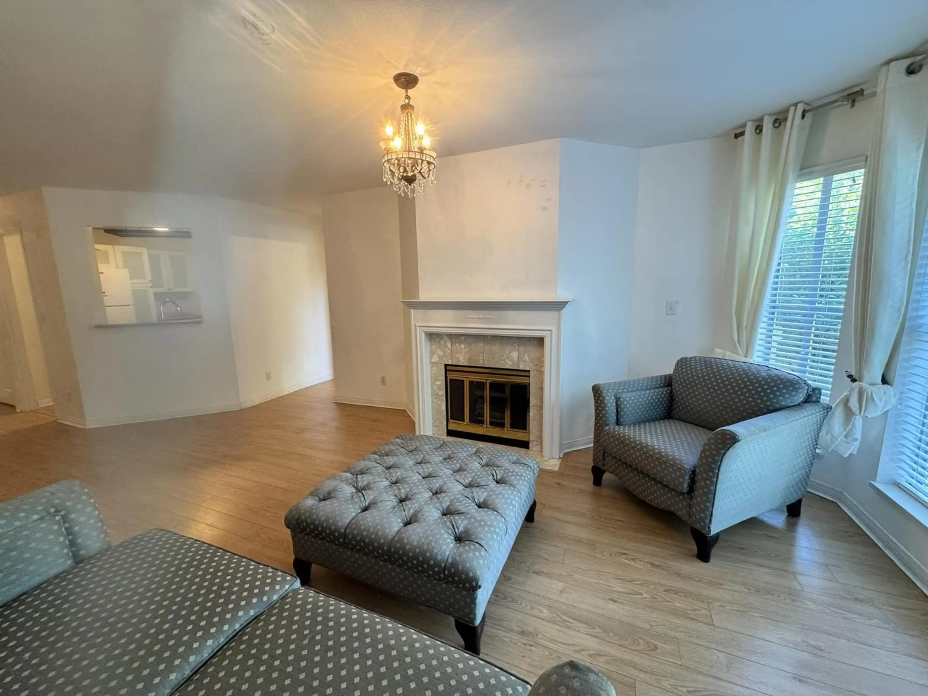 Living room with furniture, wood/laminate floor for 209 - 7171 121 STREET, Surrey British Columbia V3W1G9