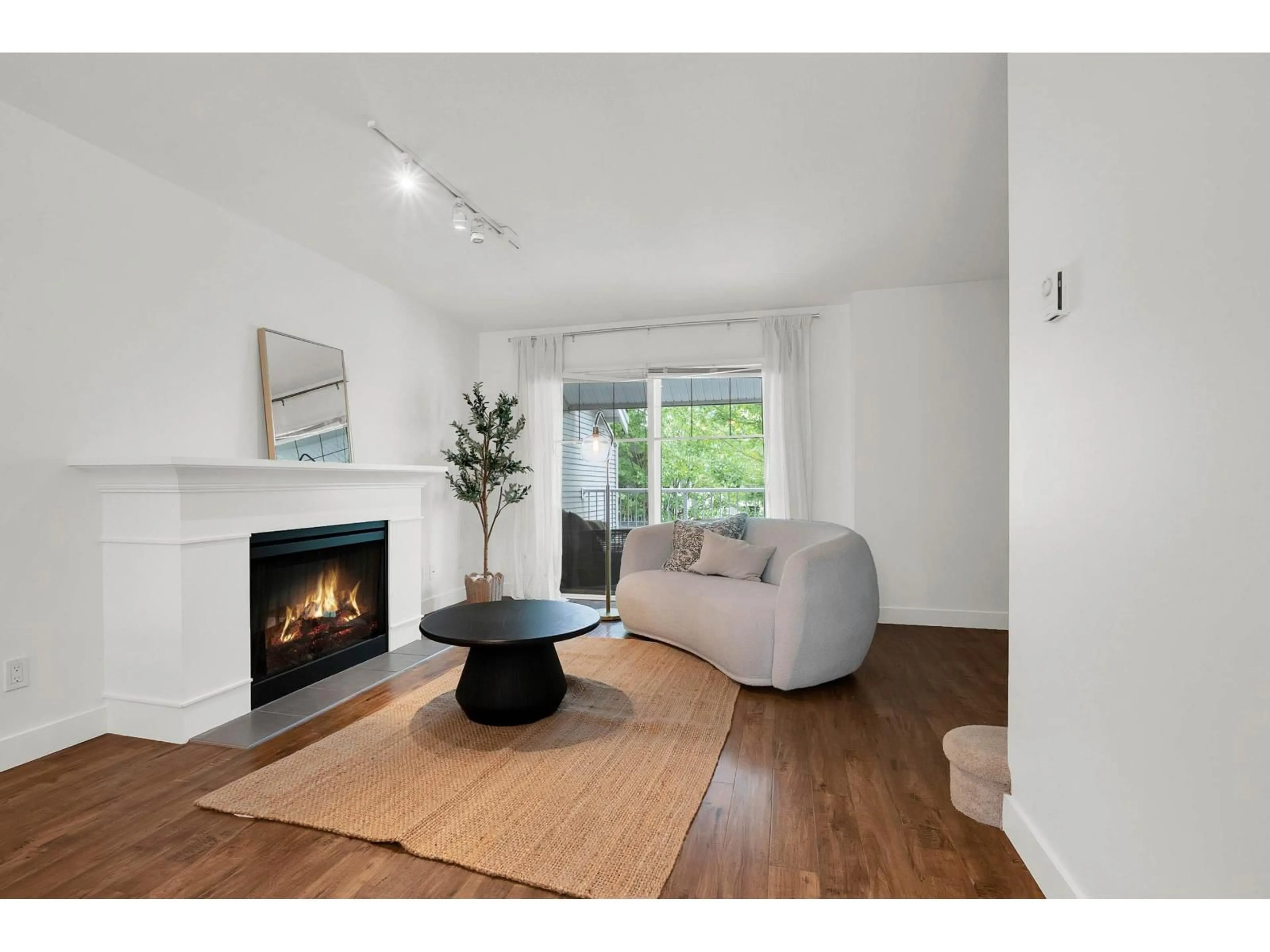 Living room with furniture, wood/laminate floor for 11 - 6555 192A STREET, Surrey British Columbia V4N0A2