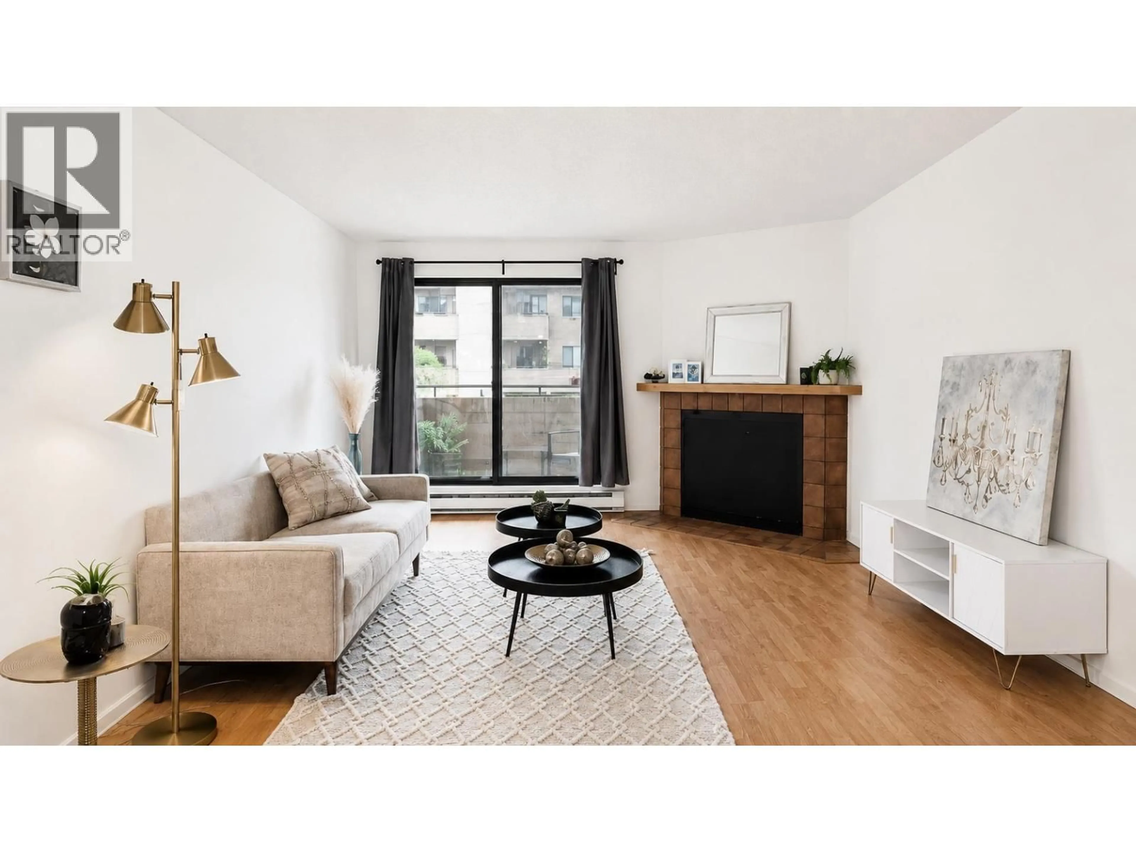 Living room with furniture, wood/laminate floor for 206 - 7295 MOFFATT ROAD, Richmond British Columbia V6Y3E5