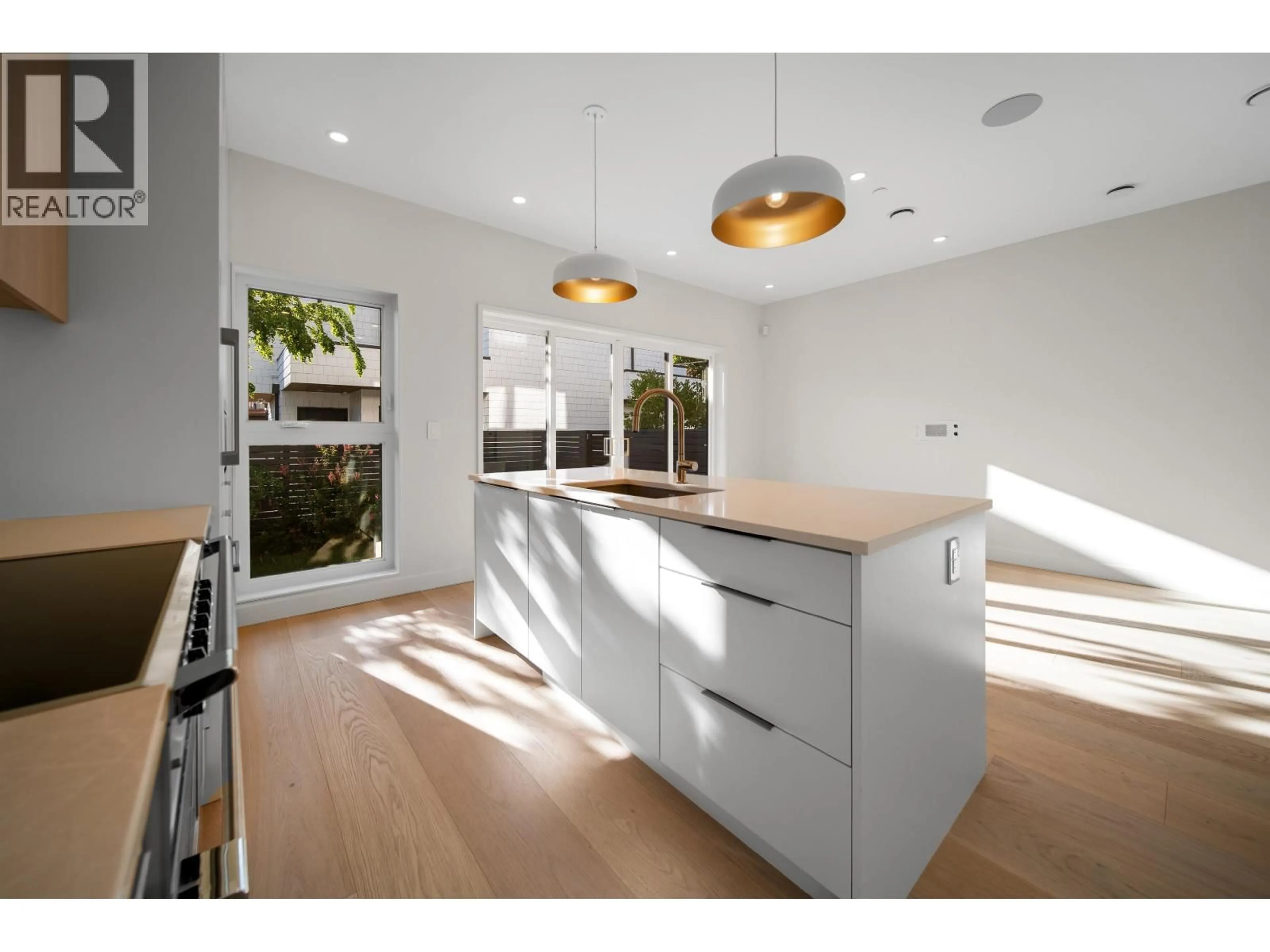 Open concept kitchen, wood/laminate floor for 5407 WALES STREET, Vancouver British Columbia V5R3M9