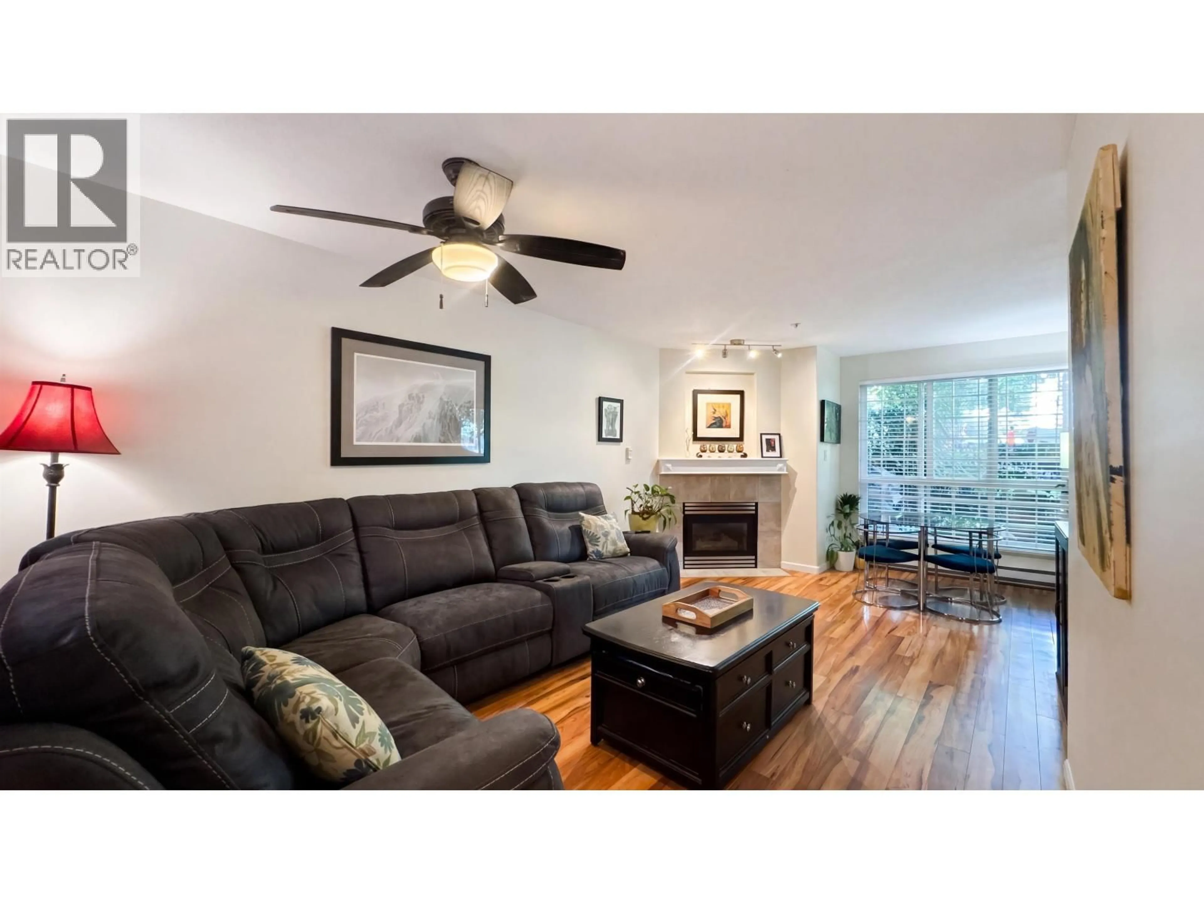 Living room with furniture, wood/laminate floor for 106 - 8495 JELLICOE STREET, Vancouver British Columbia V5S2J4