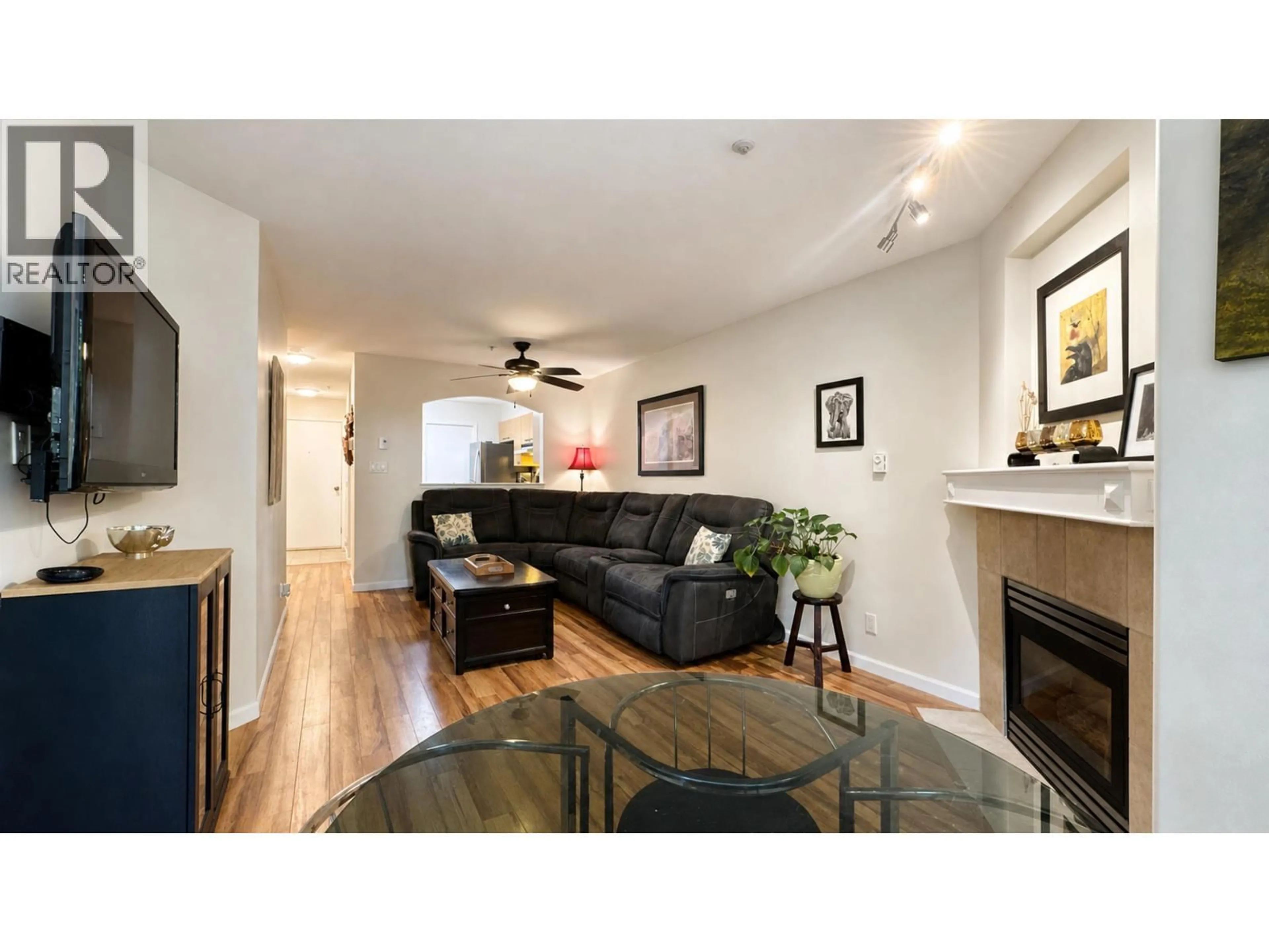 Living room with furniture, wood/laminate floor for 106 - 8495 JELLICOE STREET, Vancouver British Columbia V5S2J4