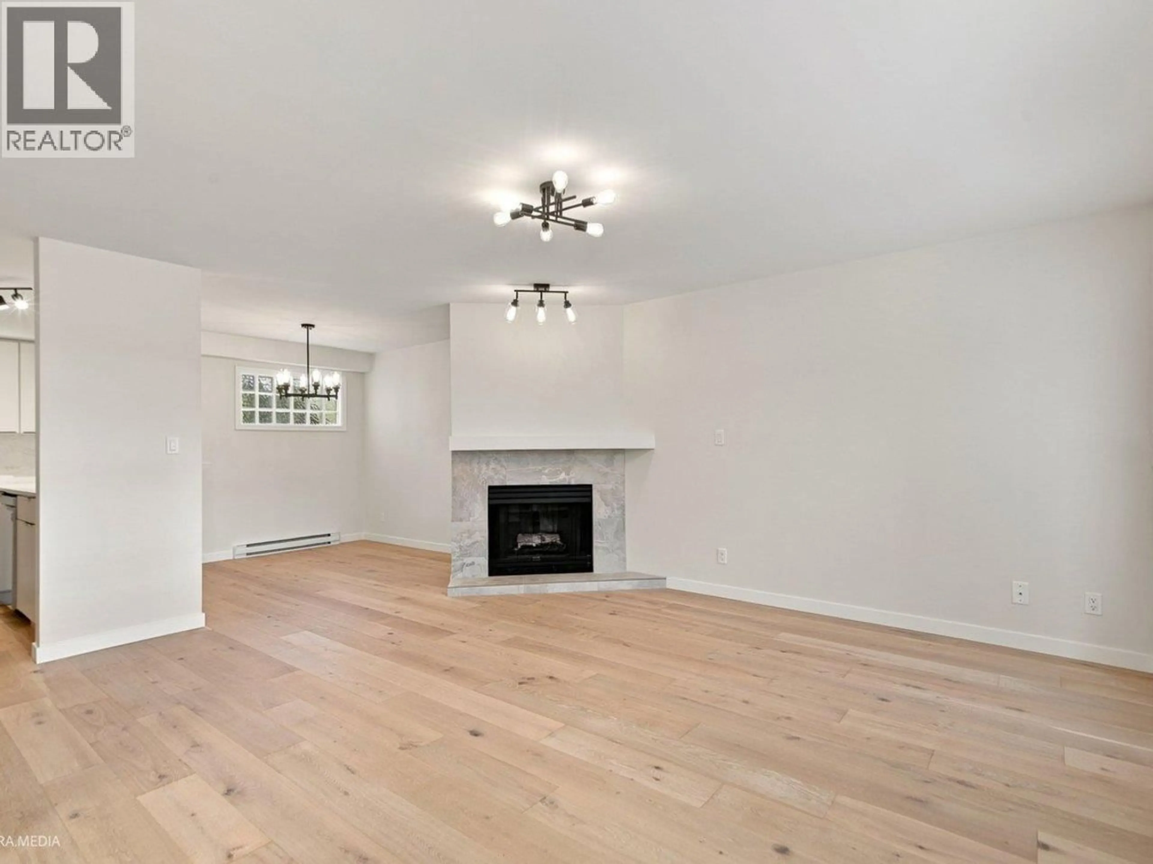 Living room with furniture, wood/laminate floor for 203 - 3787 PENDER STREET, Burnaby British Columbia V5C2L2