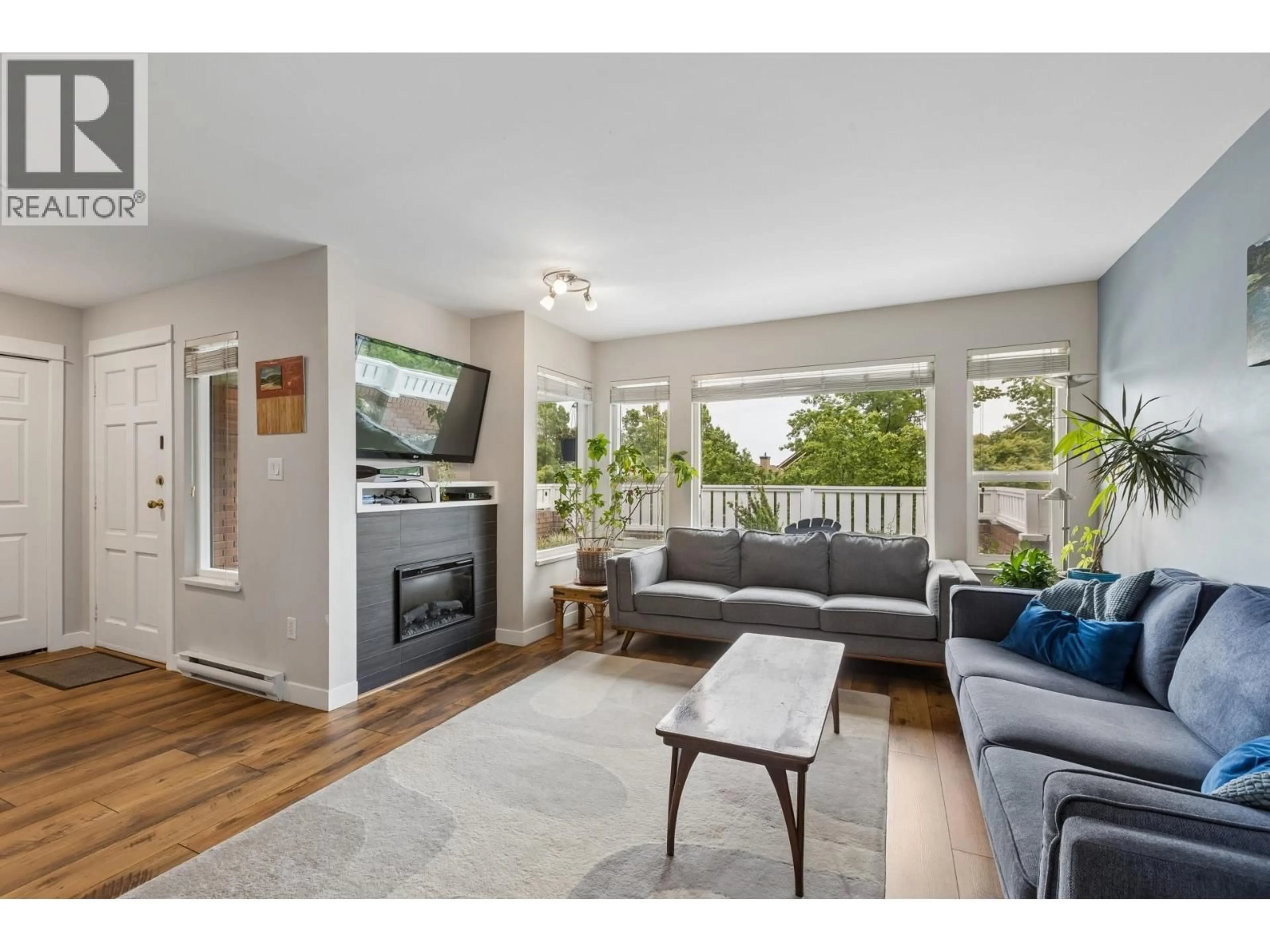 Living room with furniture, wood/laminate floor for 7 - 240 KEITH ROAD, North Vancouver British Columbia V7L1V5