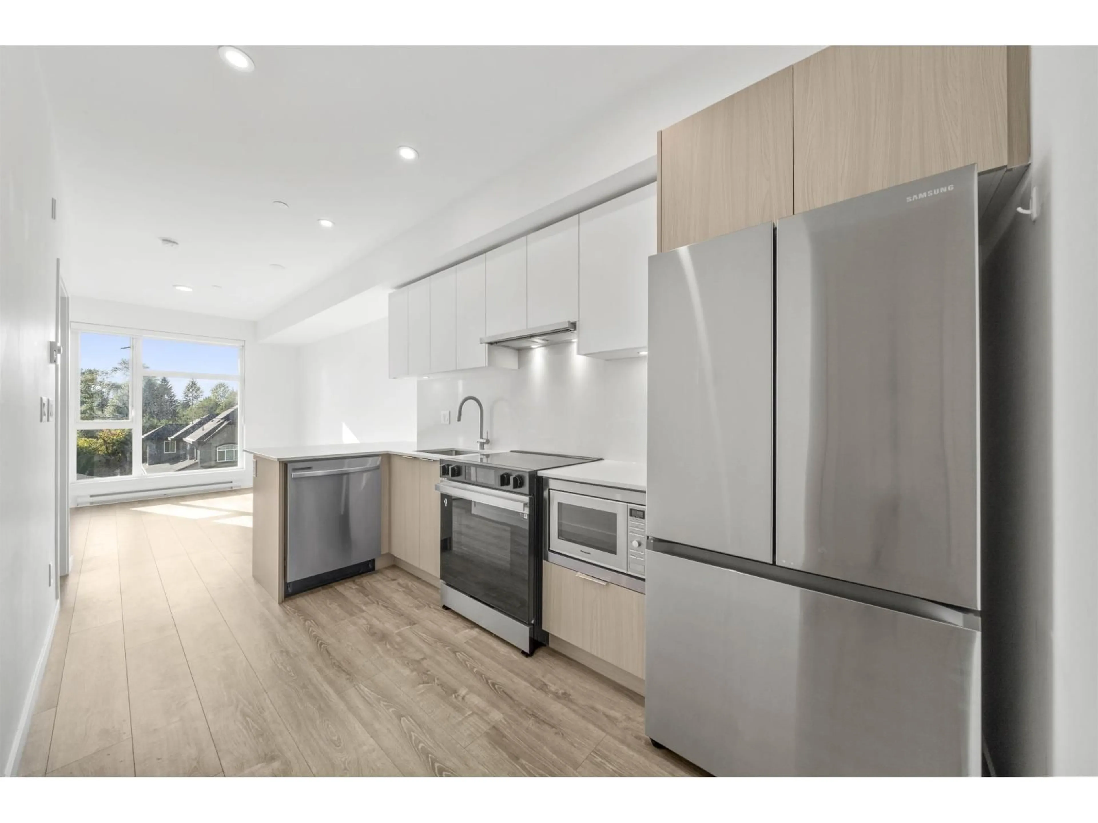 Open concept kitchen, wood/laminate floor for 305 - 10828 139A STREET, Surrey British Columbia V3R0H3