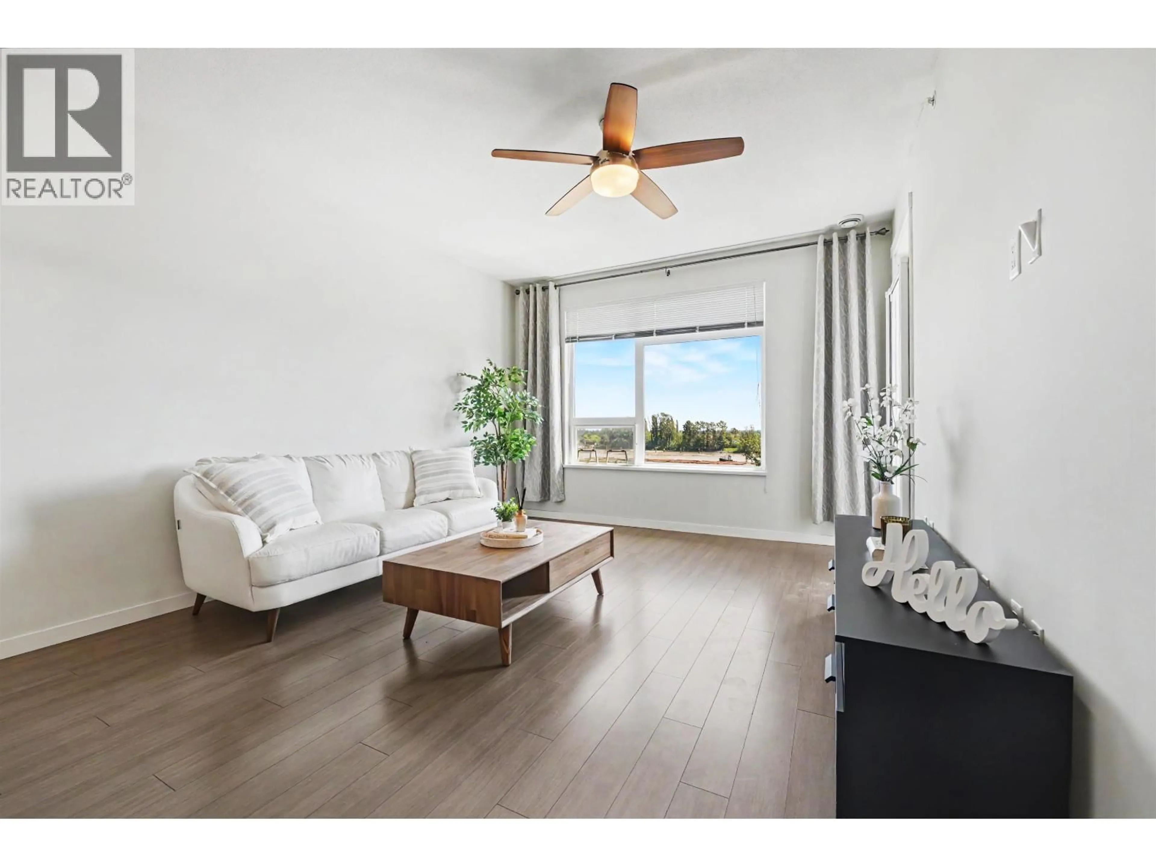 Living room with furniture, wood/laminate floor for 604 - 3289 RIVERWALK AVENUE, Vancouver British Columbia V5S0G2