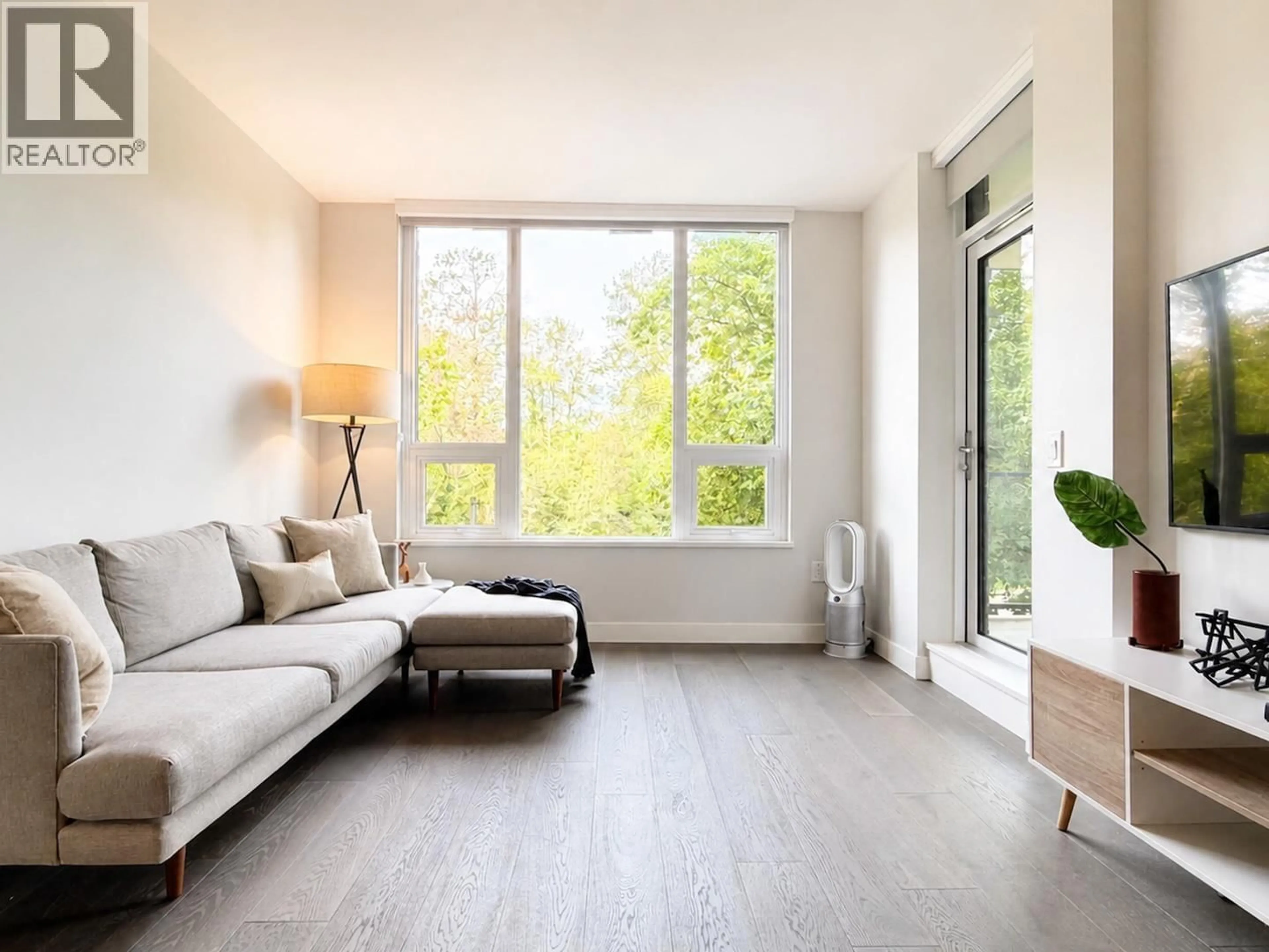 Living room with furniture, wood/laminate floor for 303 - 5410 SHORTCUT ROAD, Vancouver British Columbia V6T0C8
