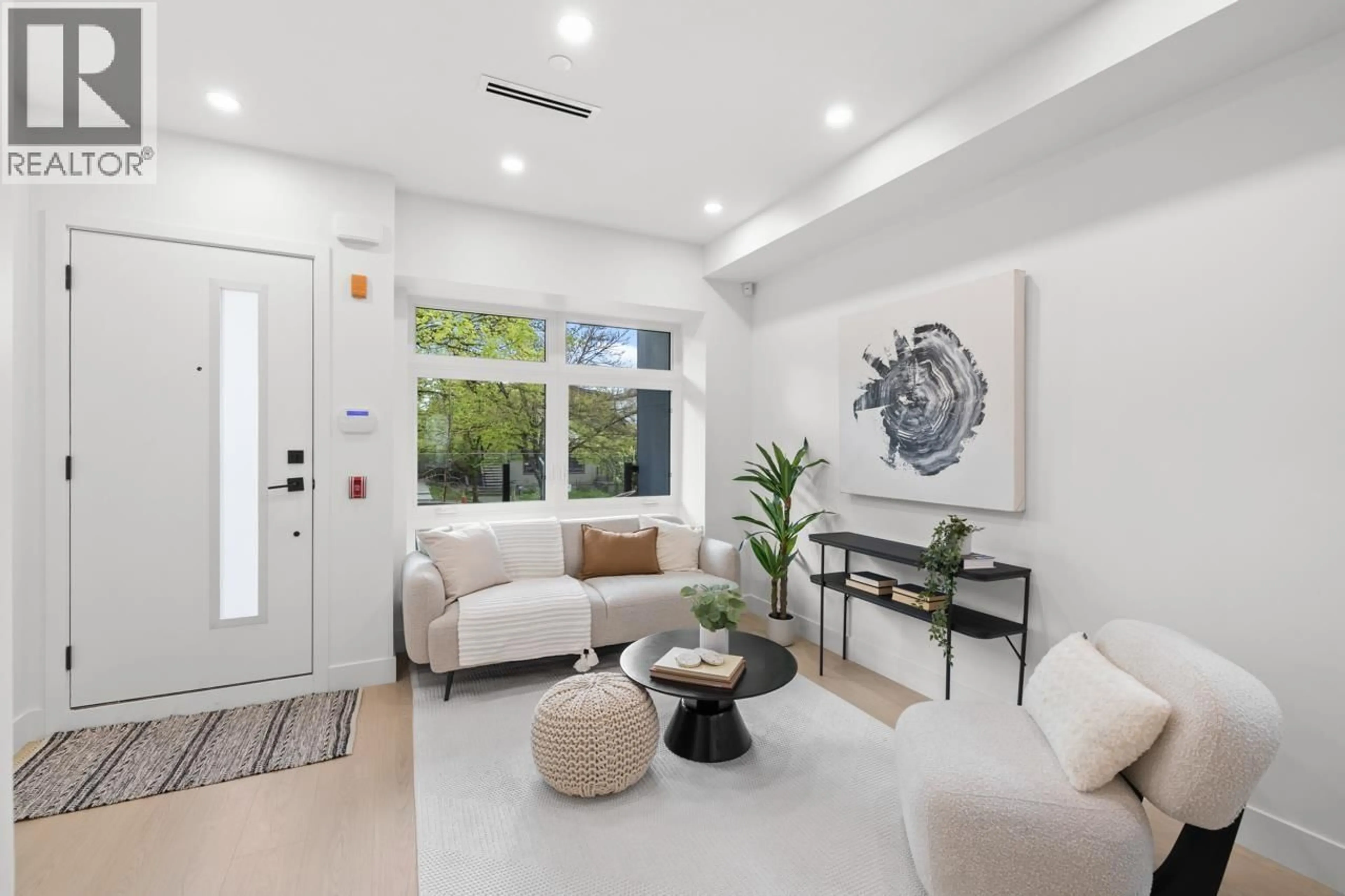 Living room with furniture, ceramic/tile floor for 201 - 2135 PENDER STREET, Vancouver British Columbia V5L1X3