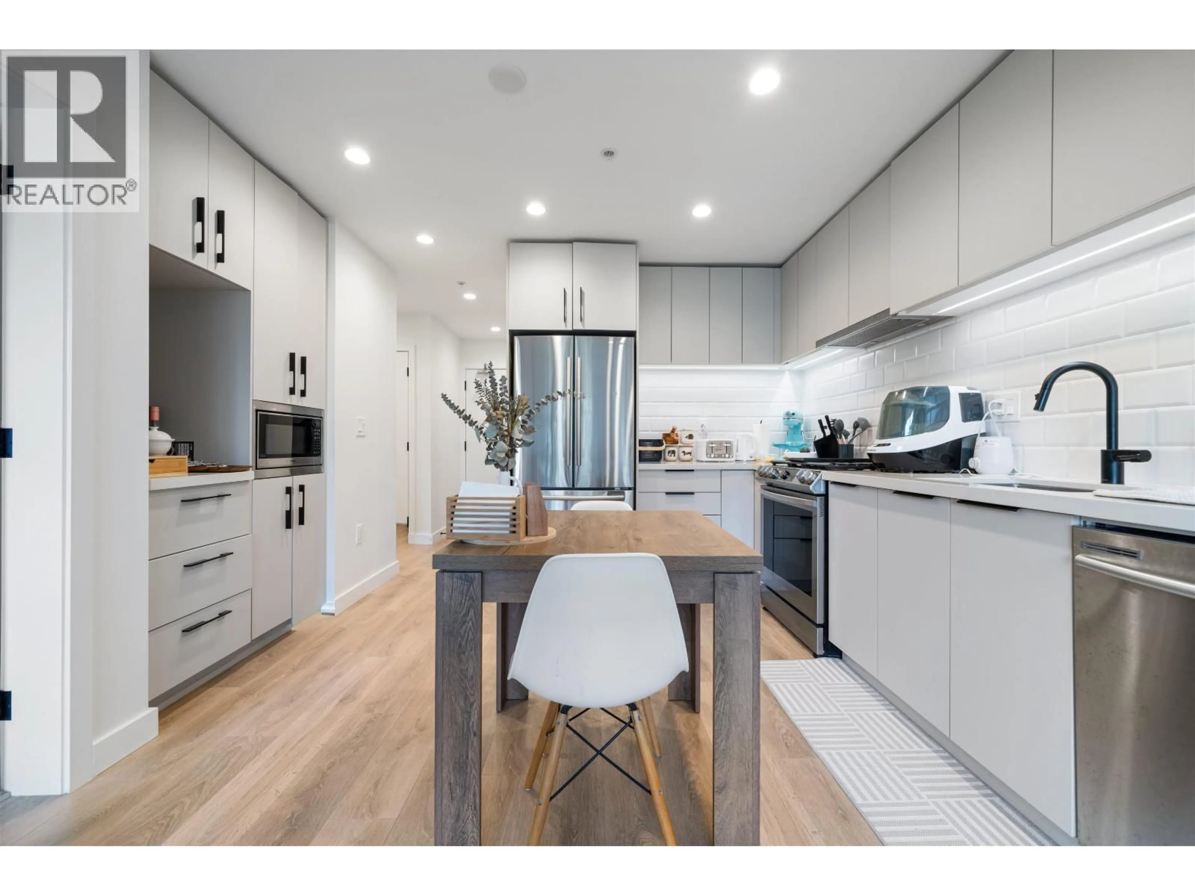 Open concept kitchen, wood/laminate floor for 303 - 3038 ST GEORGE STREET, Port Moody British Columbia V3H0L3
