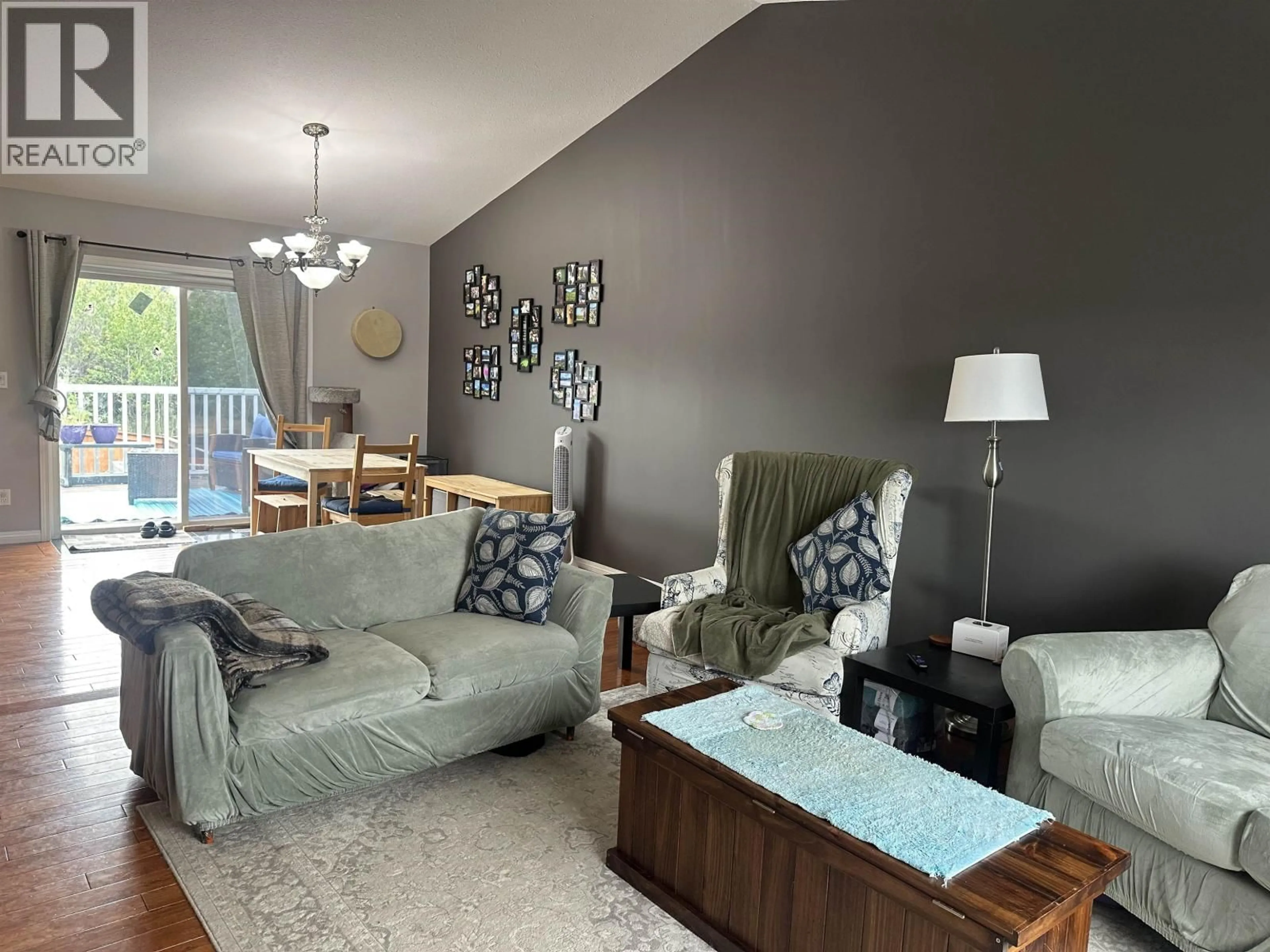 Living room with furniture, wood/laminate floor for 9103 118 AVENUE, Fort St. John British Columbia V1J7J4