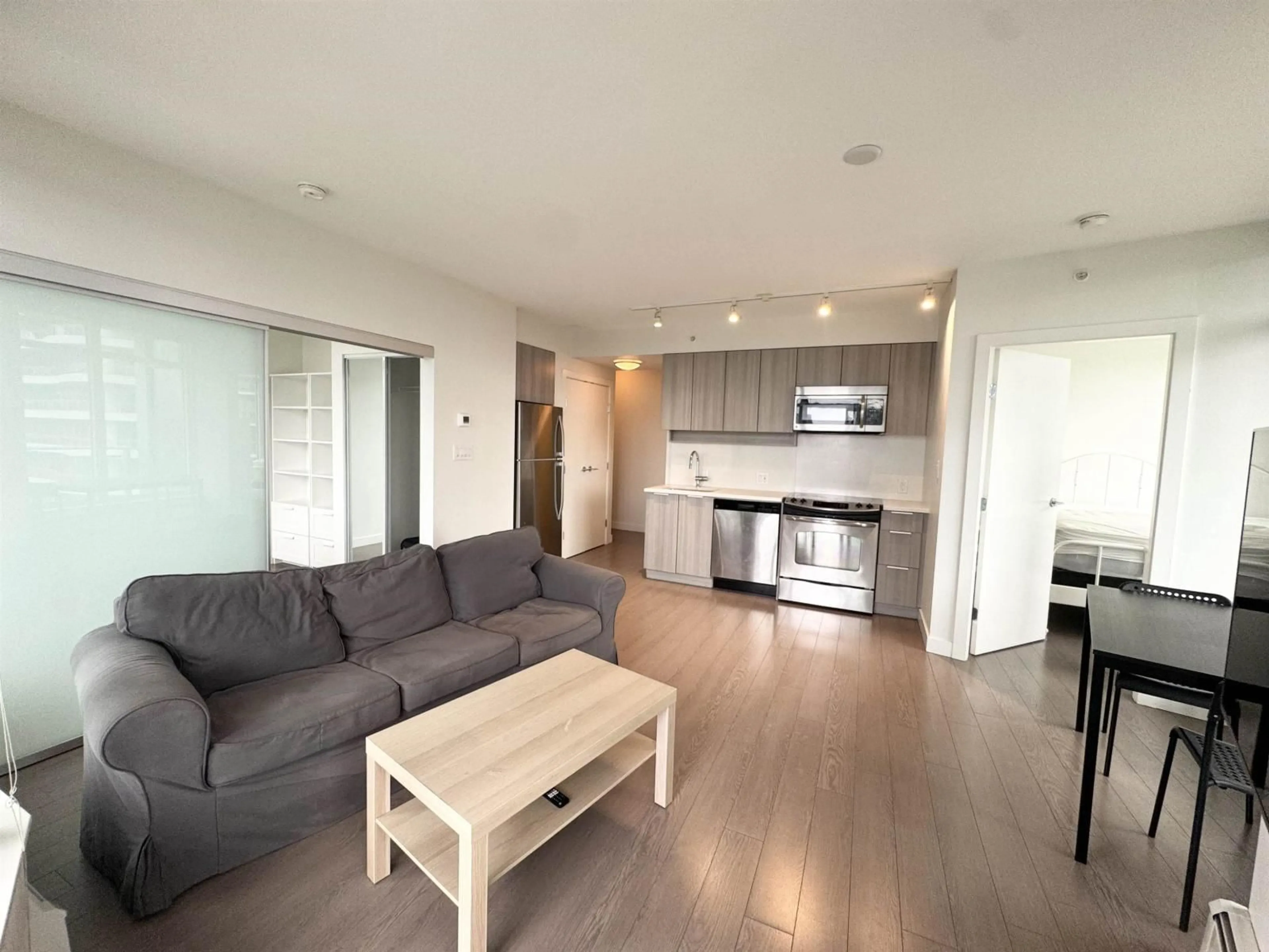 Living room with furniture, wood/laminate floor for 1112 - 13308 CENTRAL AVENUE, Surrey British Columbia V3T0M4