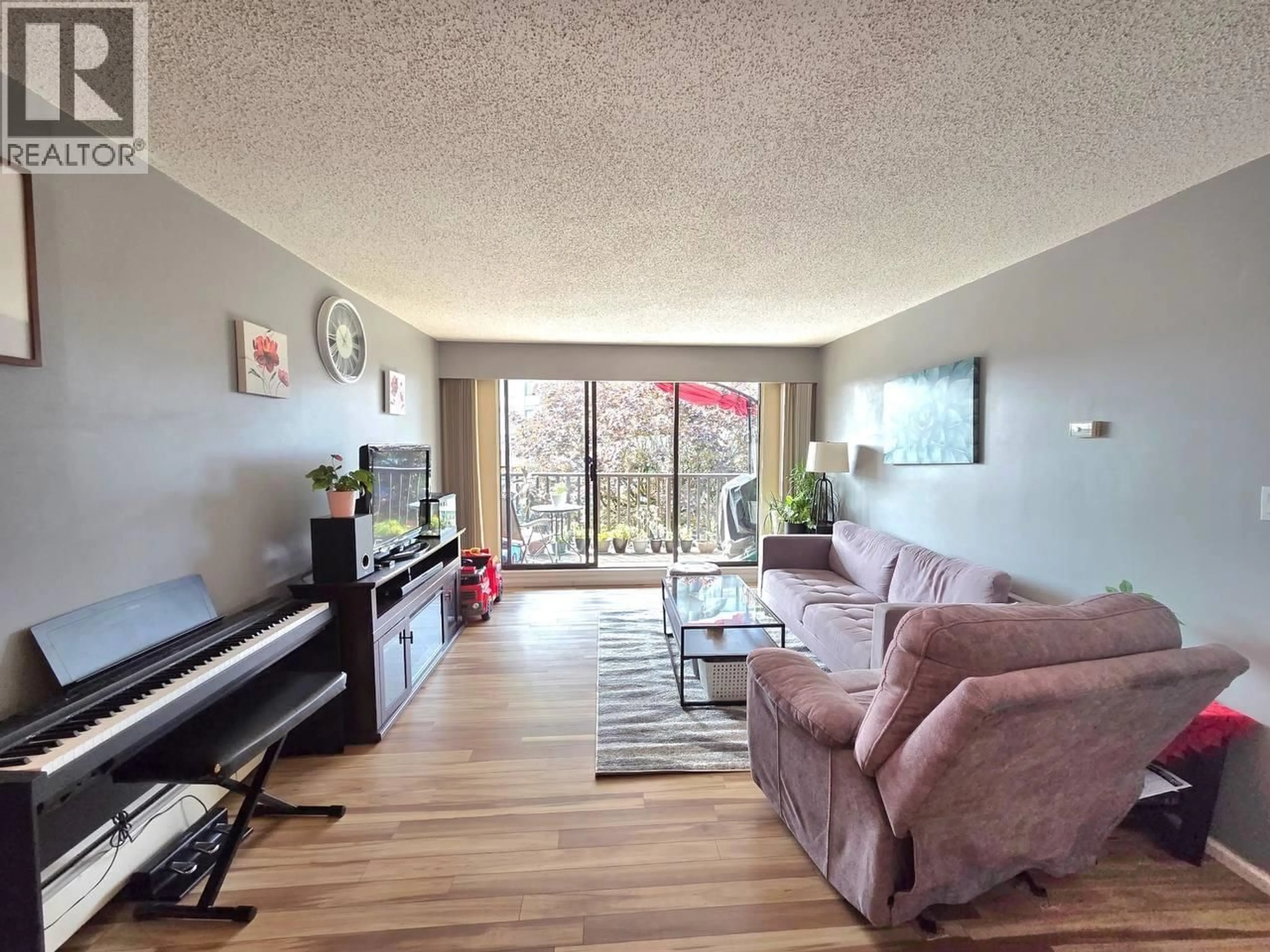 Living room with furniture, wood/laminate floor for 107 - 170 3RD STREET, North Vancouver British Columbia V7L1E6