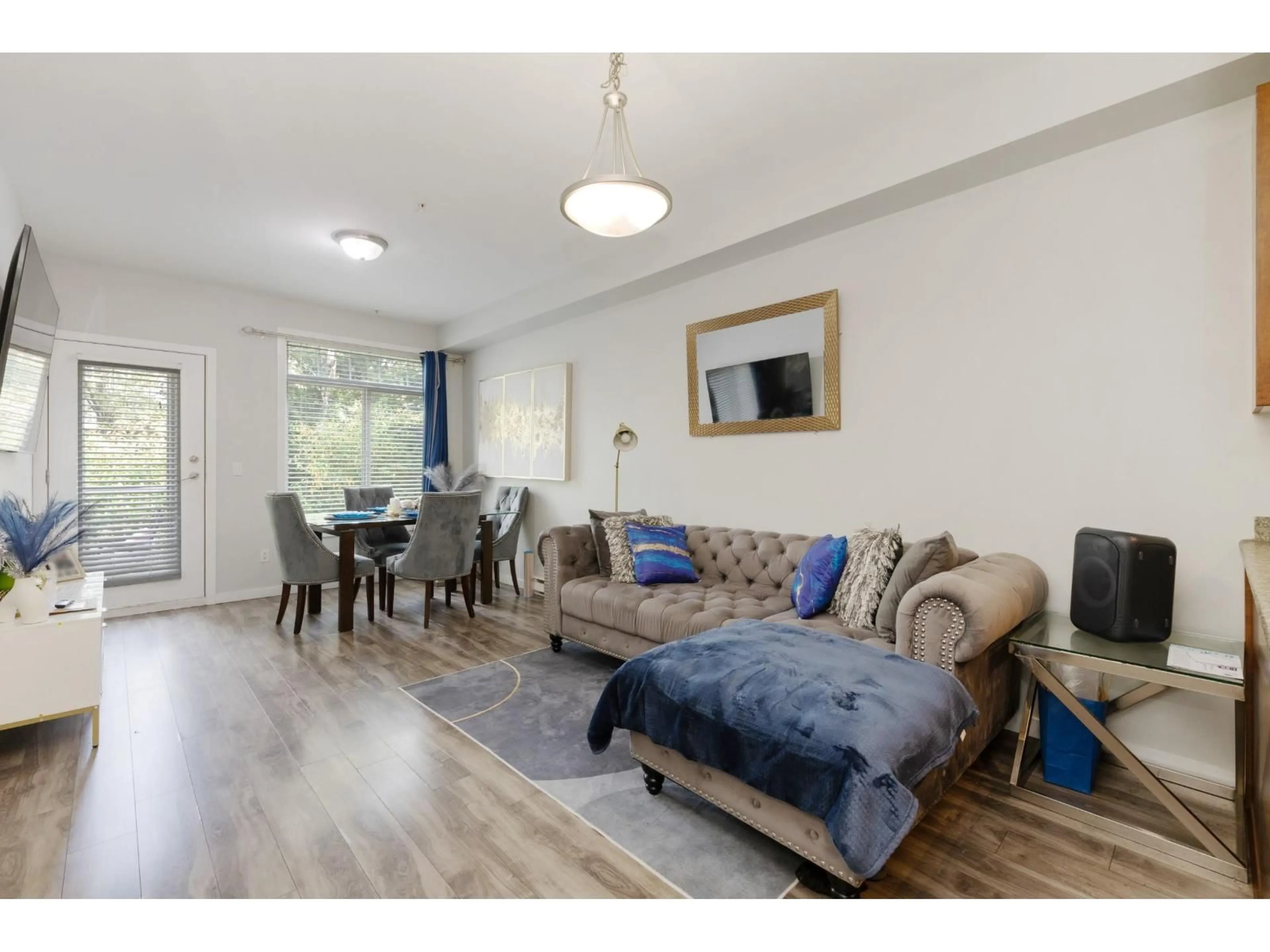 Living room with furniture, wood/laminate floor for 202 - 13277 108 AVENUE, Surrey British Columbia V3T0A9