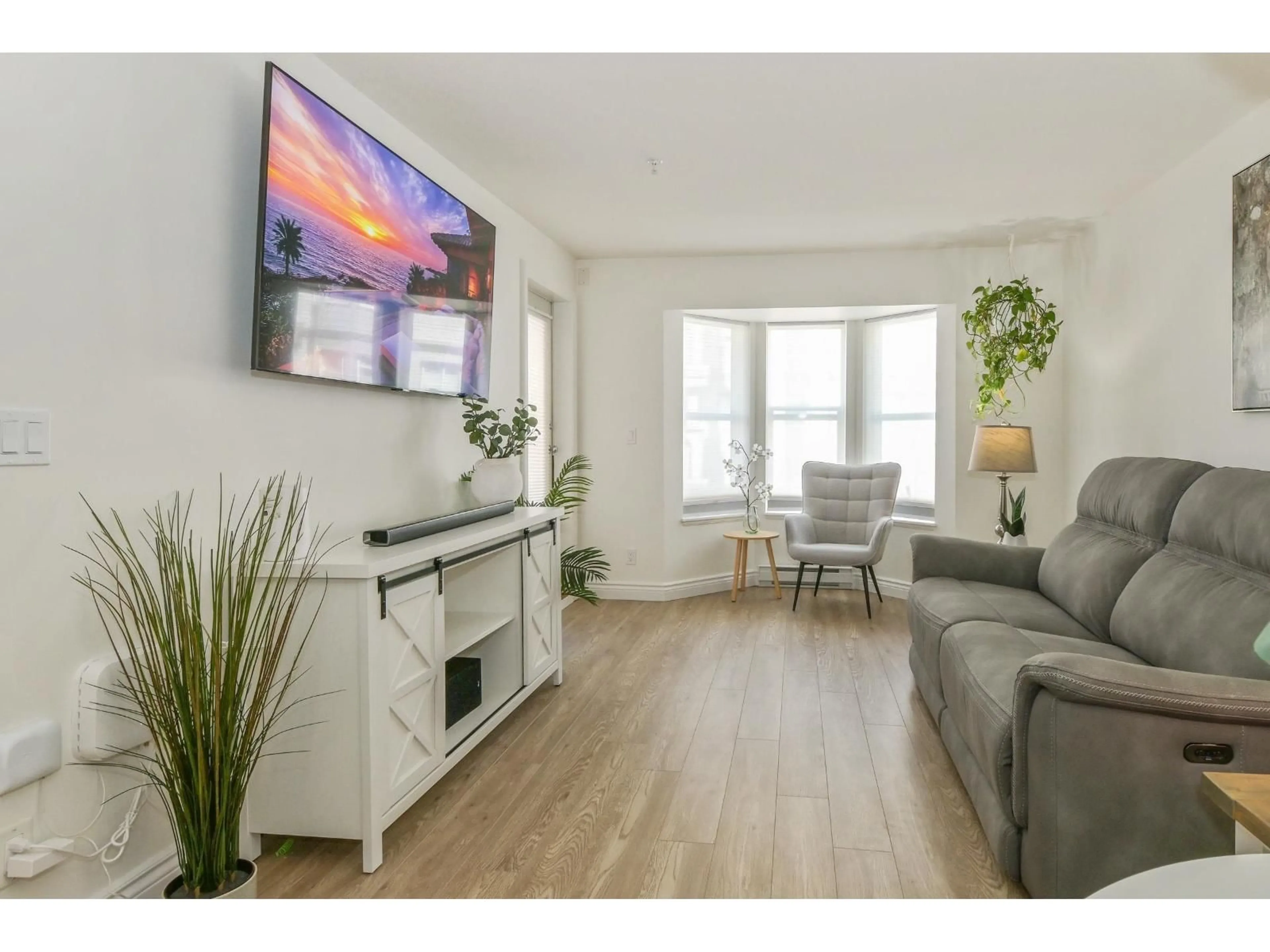 Living room with furniture, wood/laminate floor for 209 - 5454 198 STREET, Langley British Columbia V3A1G2