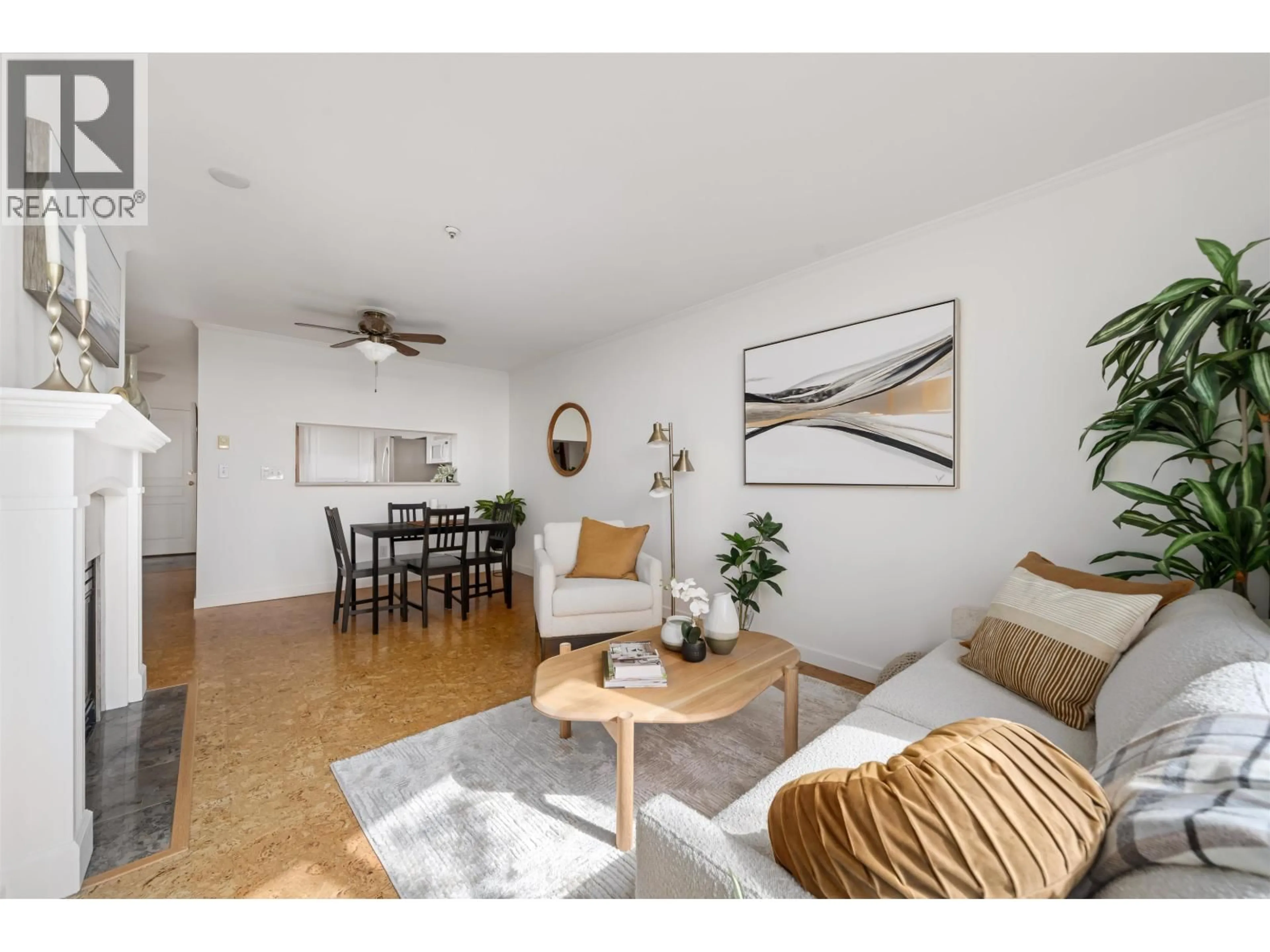 Living room with furniture, wood/laminate floor for 409 - 8430 JELLICOE STREET, Vancouver British Columbia V5S4S7