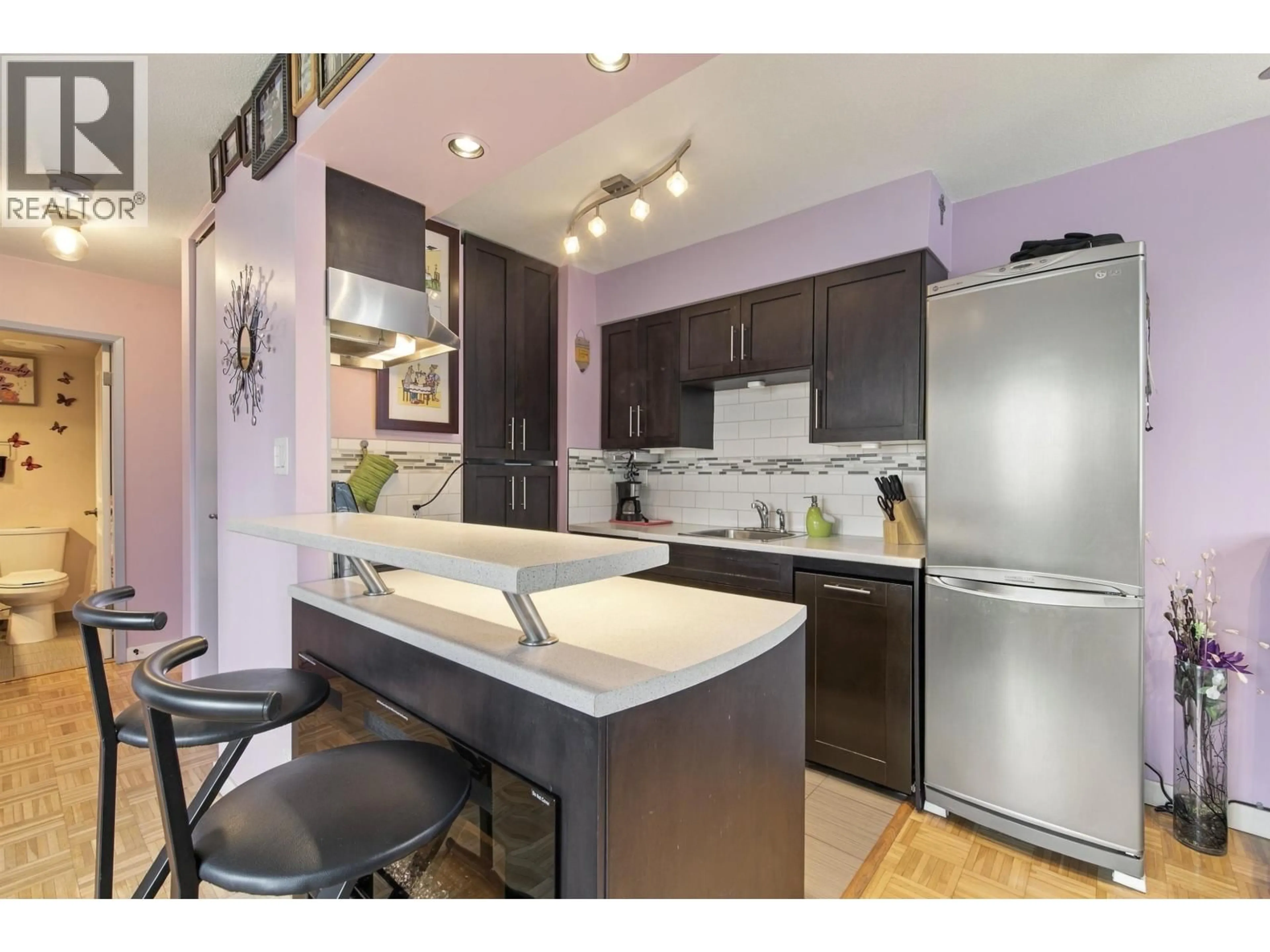 Open concept kitchen, wood/laminate floor for 705 - 1251 CARDERO STREET, Vancouver British Columbia V6G2H9