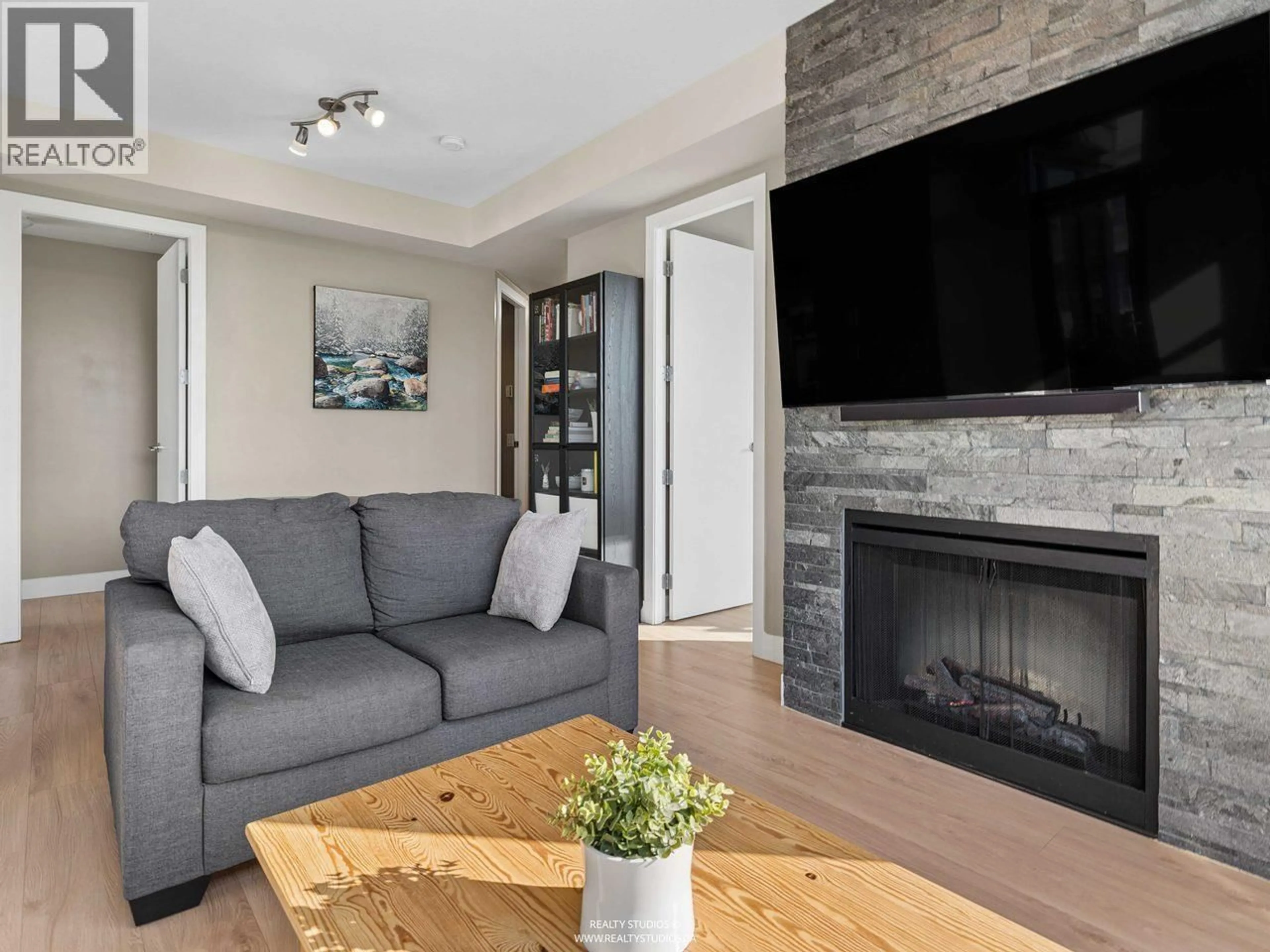 Living room with furniture, wood/laminate floor for 901 - 9300 UNIVERSITY CRESCENT, Burnaby British Columbia V5A4X9