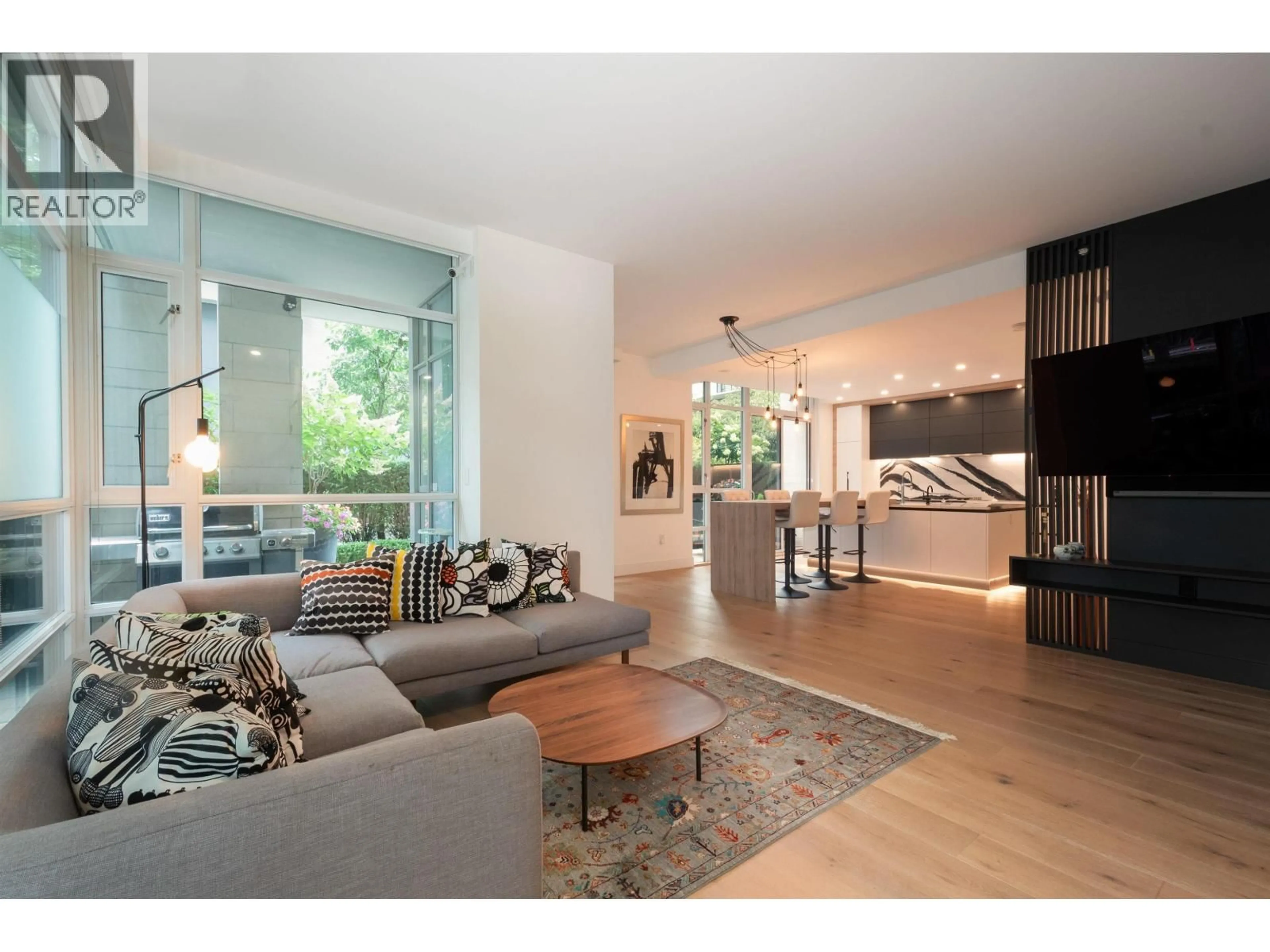 Living room with furniture, wood/laminate floor for 180 ATHLETES WAY, Vancouver British Columbia V5Y0B5