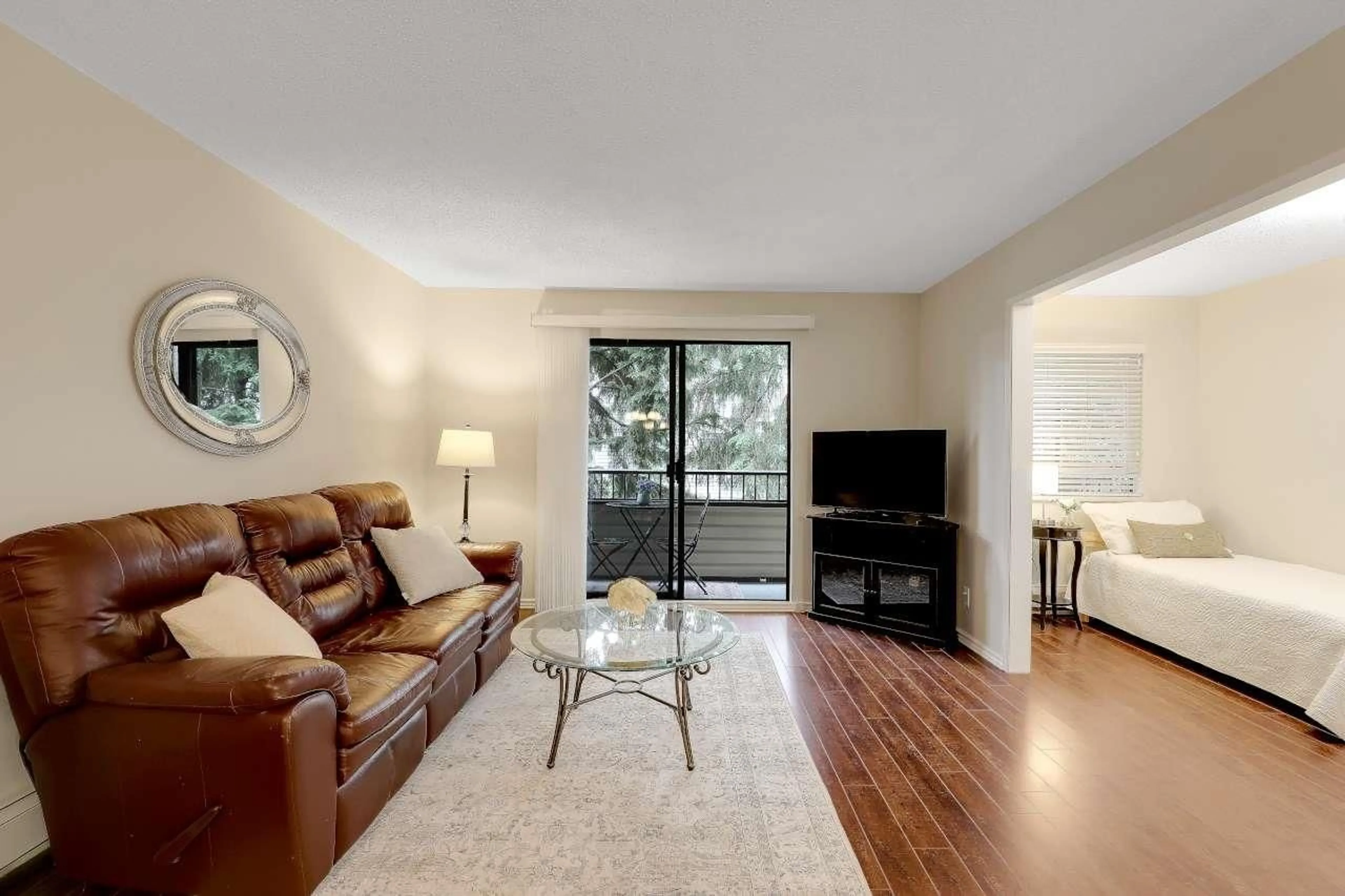 Living room with furniture, wood/laminate floor for 211 - 20460 54 AVENUE, Langley British Columbia V3A6N6